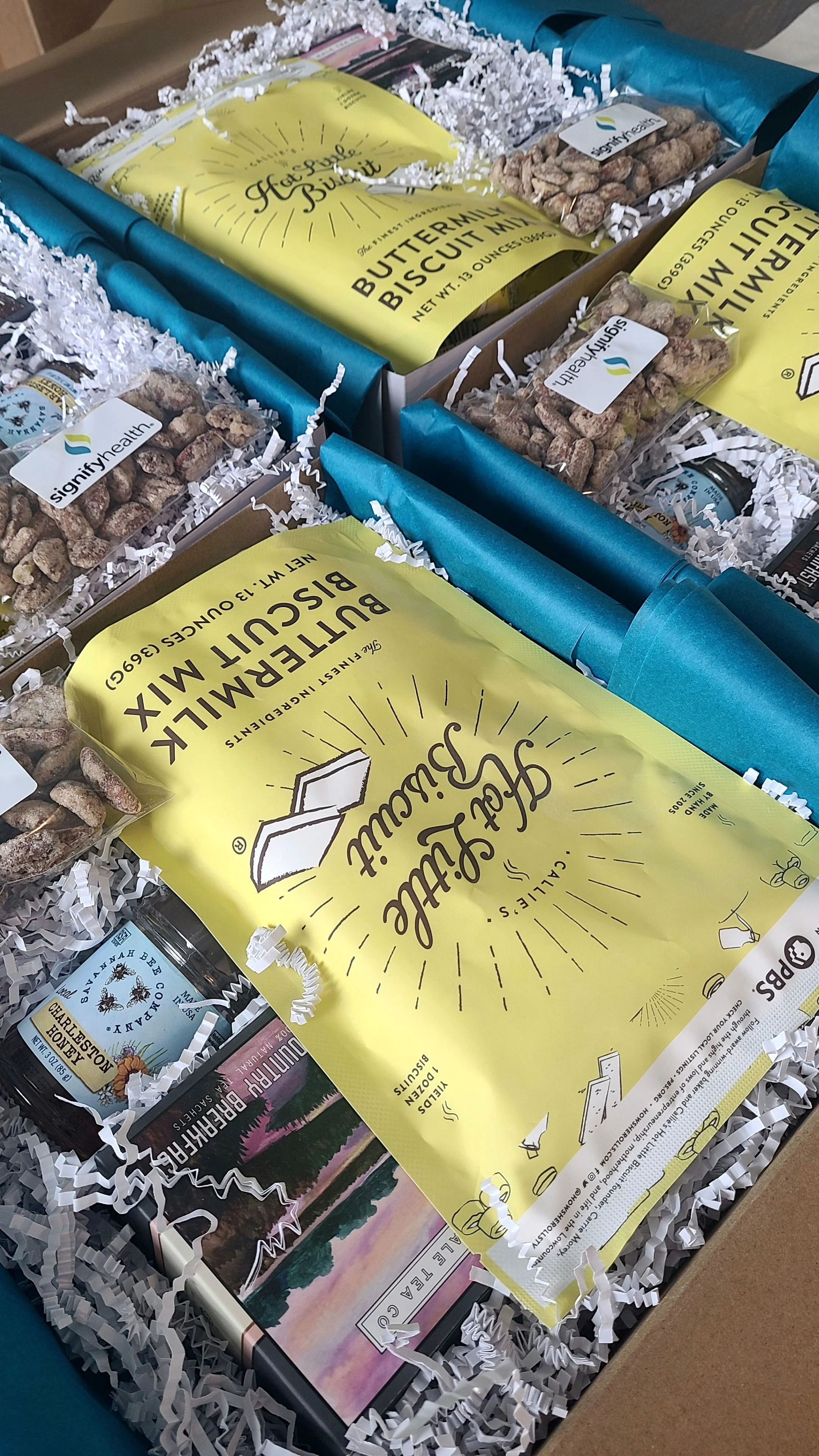 Overhead view of thoughtfully curated Lowcountry welcome gift boxes featuring Charleston-inspired breakfast items for corporate guests at The Sanctuary at Kiawah Island.