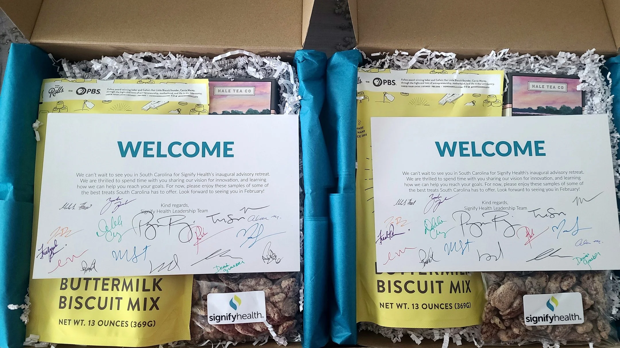 Overhead view of custom Charleston-inspired corporate welcome gift boxes at Kiawah Island Golf Resort's The Sanctuary featuring locally sourced Lowcountry items and a personalized welcome note.
