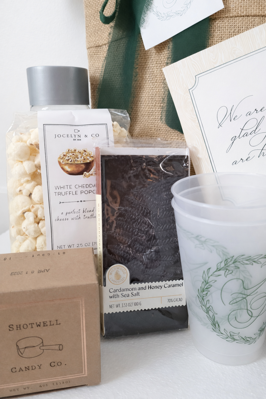 Custom wedding welcome gifts for an Auberge Mayflower Inn wedding in Washington, CT featuring Shotwell Candy Co. caramels, truffle popcorn, Wildwood Chocolate and monogrammed cups.