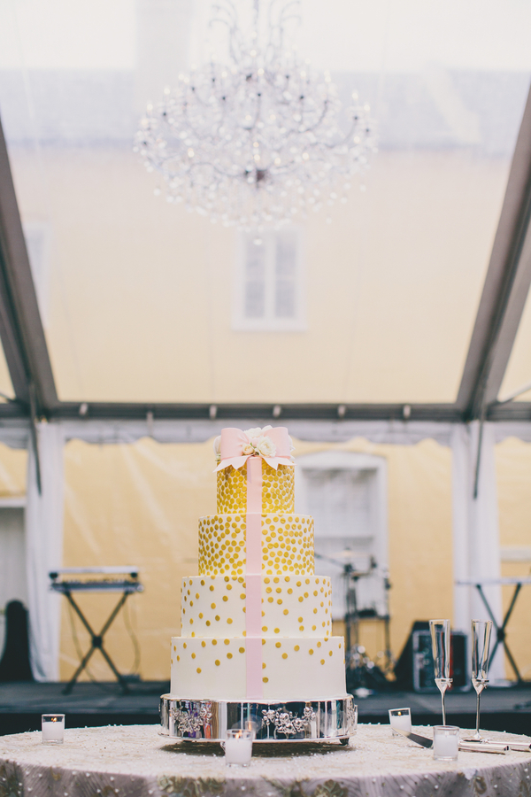 Gold wedding cake with pink ribbon at William Aiken House