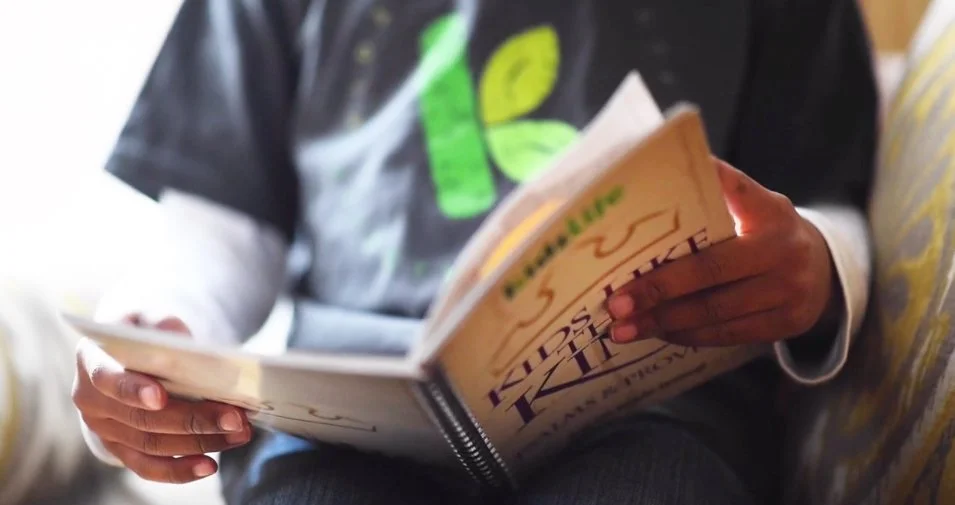KidzLife student reading a journal