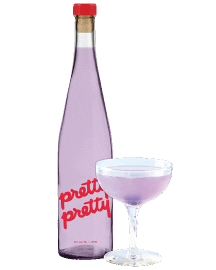 A bottle of Pretty Pretty next to a cocktail glass