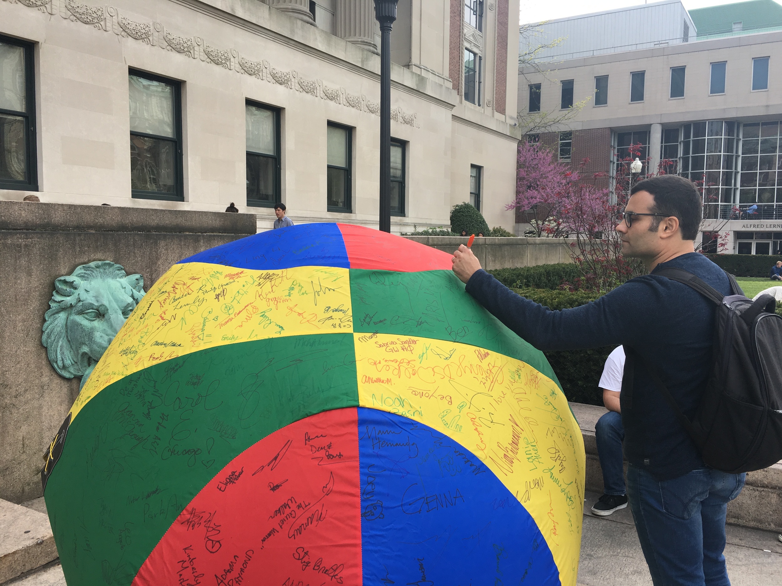 Murilo engaging in campus activism by signing this beach ball to donate money to the Children's Hospital at NewYork-Presbyterian/Columbia University Medical Center.