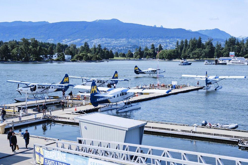 seaplanes at Jack Poole Plaza in Vancouver with the mountains and harbor behind
