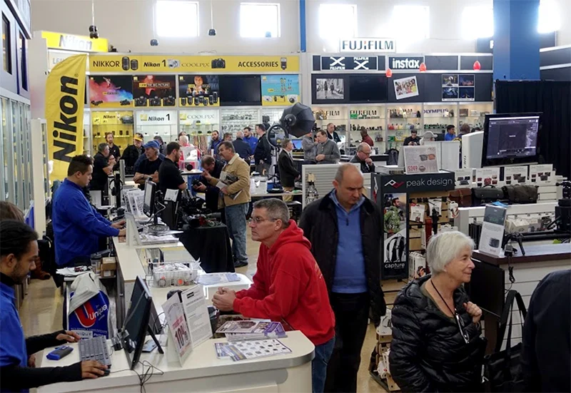 A photo of me working the sales counter during a big expo style event in my earlier years at Unique Photo in Fairfield, New Jersey. I miss the people, but not the neon blue shirt.