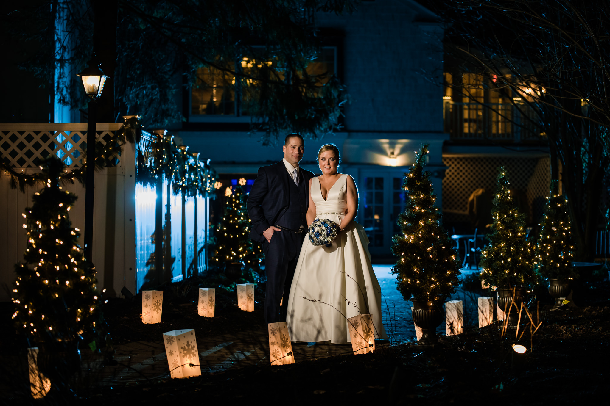 Bride and groom during their winter wedding at the grain house in basking ridge new jersey with blue and orange Christmas themed lights