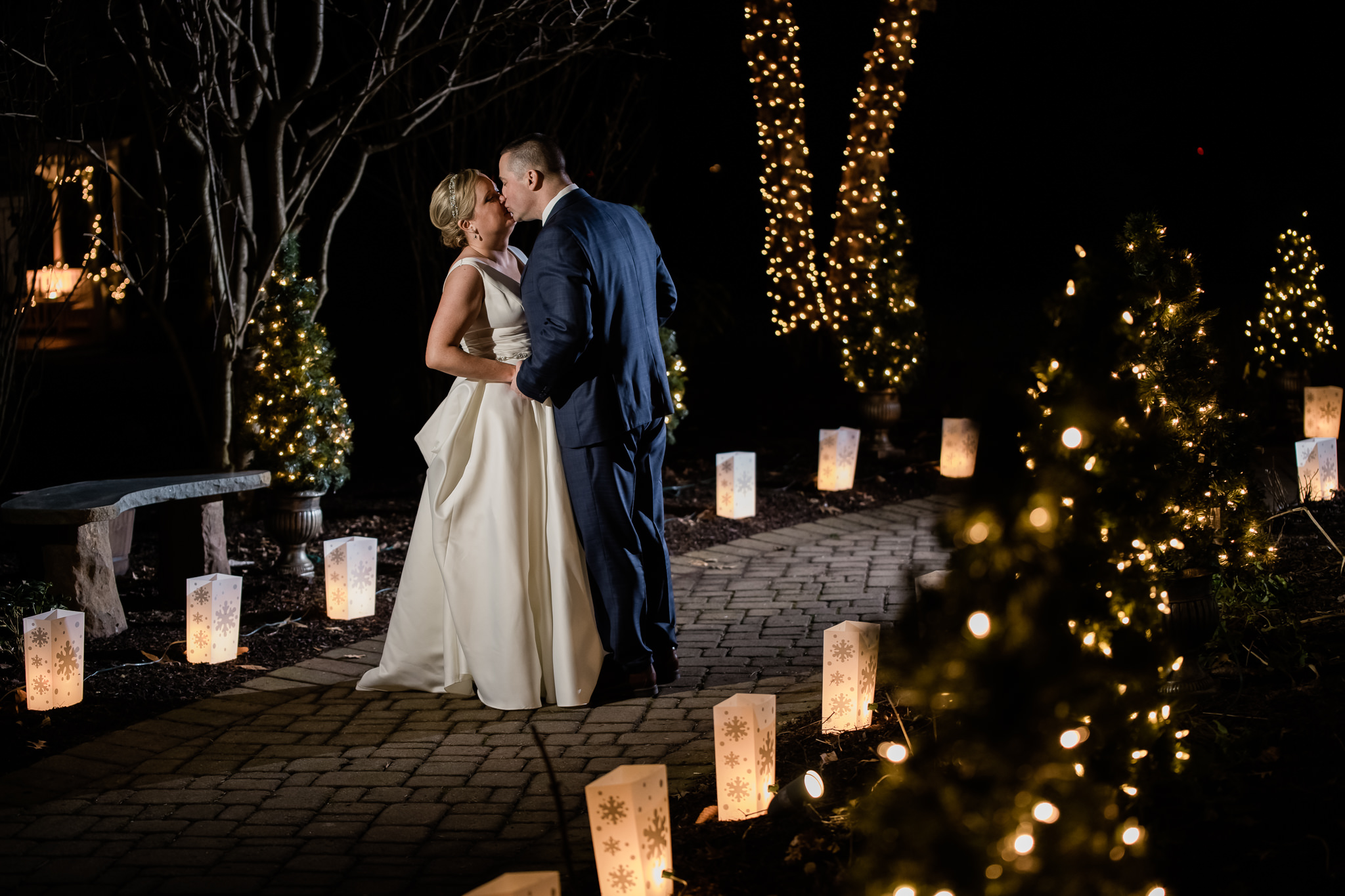 Bride and groom during their winter wedding at the grain house in basking ridge new jersey with blue and orange Christmas themed lights