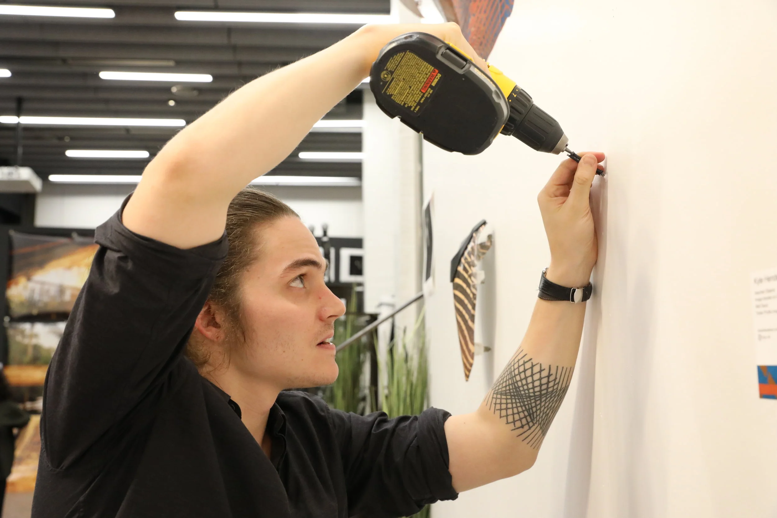 Kyle Henderson installing his work.