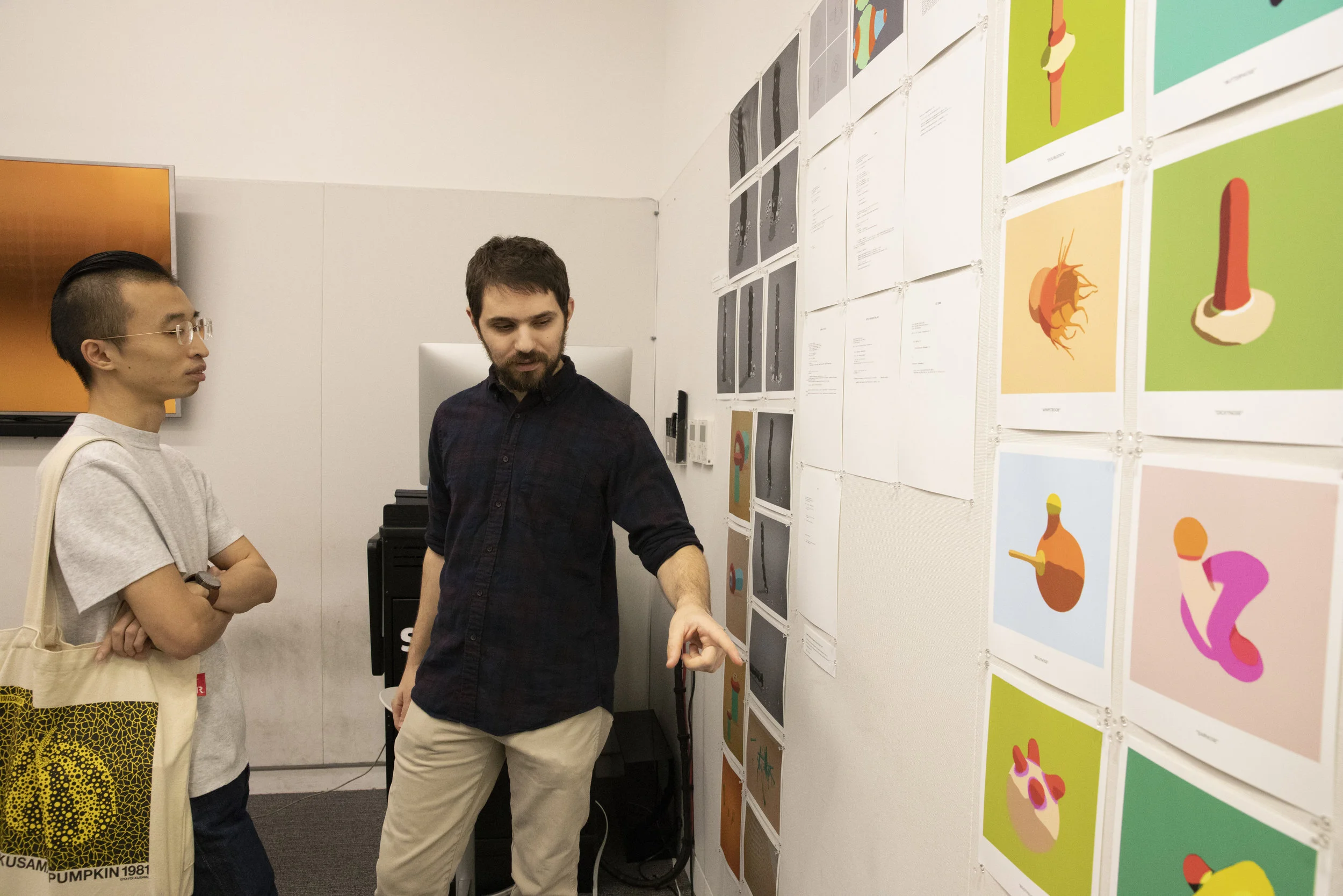 Petros Lales presents his 3D modeled organelles to a fellow student.
