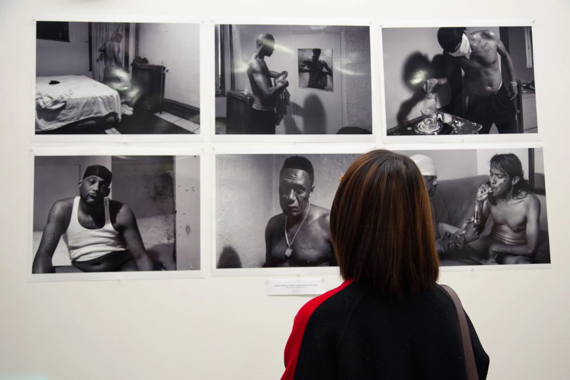 A guest gazes at the works of thesis student David Cade.
