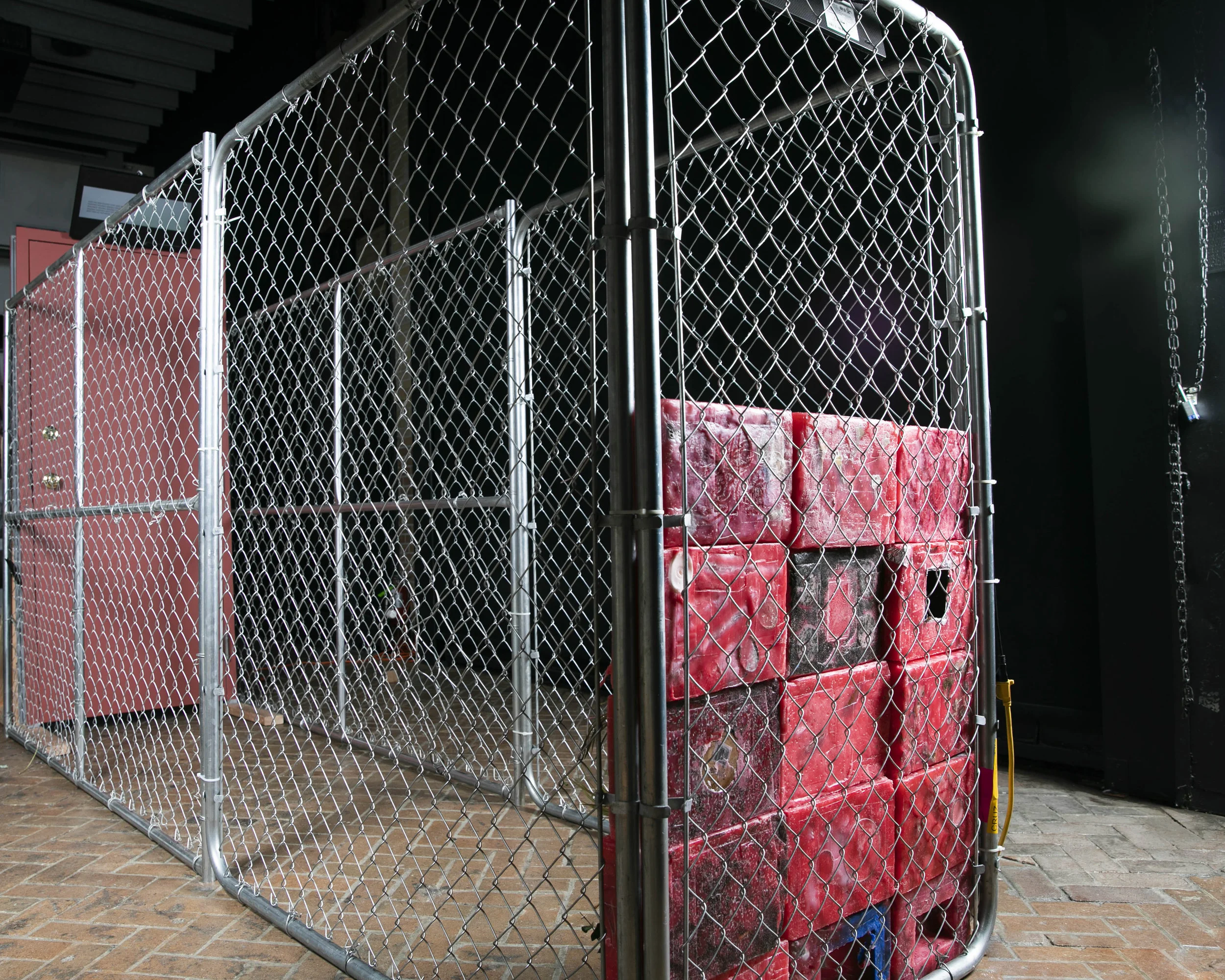 Traumatic Iterations , 2019, installation view, sculpture, 3 feet x 10 feet x 6 feet, votive wall, steel door, cage