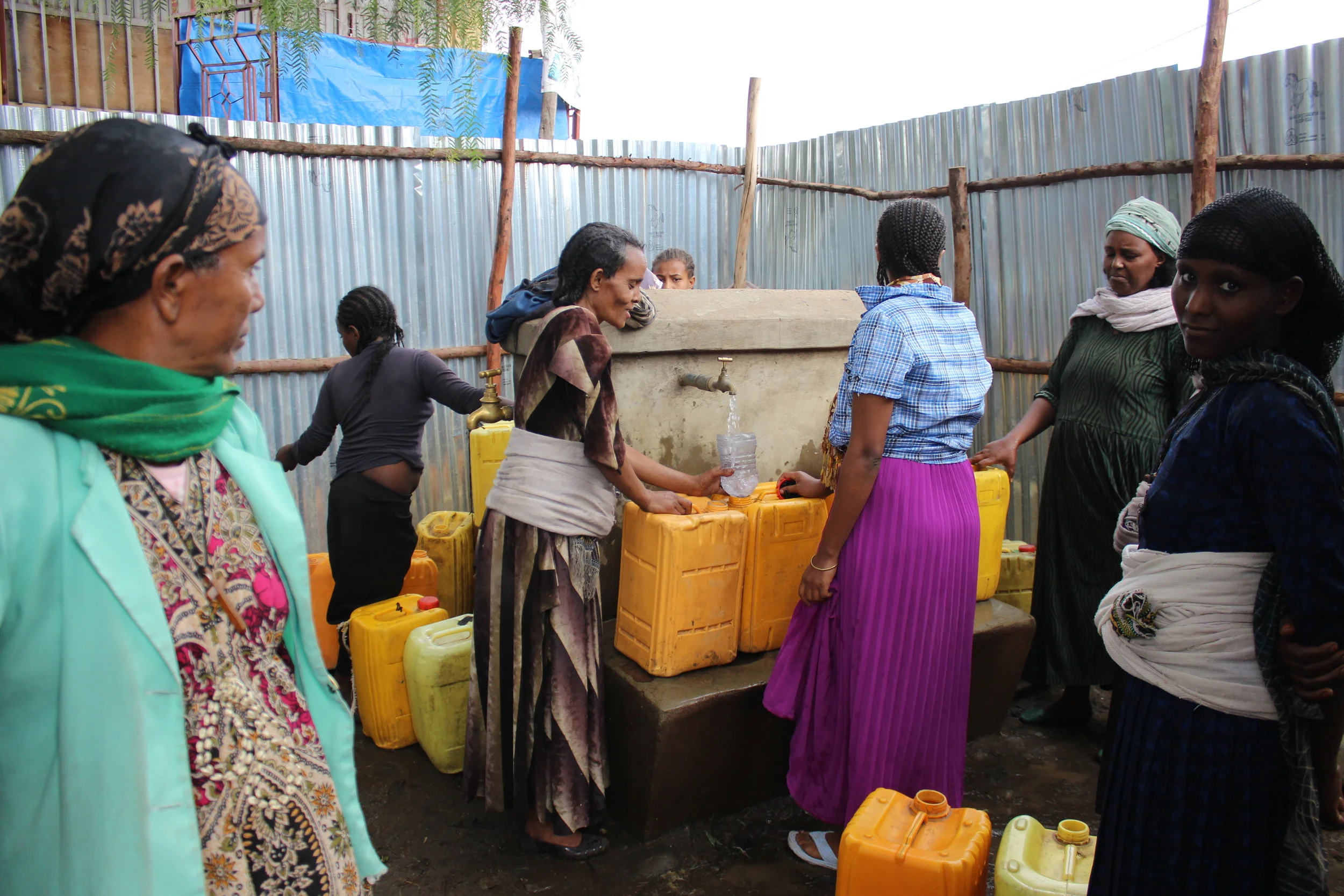 Women in the town of Rema gather at an SEF-funded solar pumping facility. Before the solar pump was installed, these women walked 6 miles each day to collect water. (Photo: Brittany Gibbons)