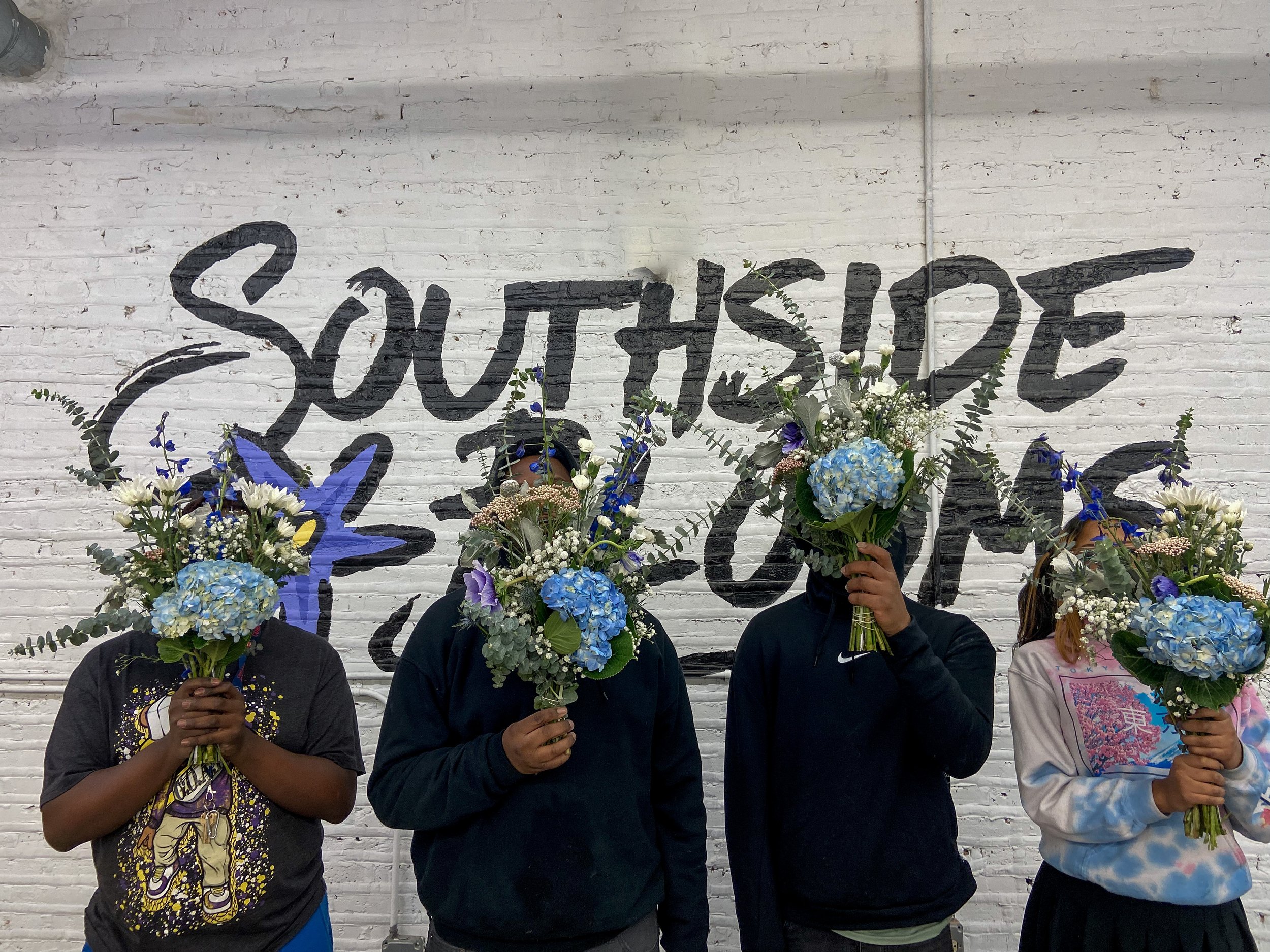 Students_Holding_Up_Handcrafted_Bouquets.JPG