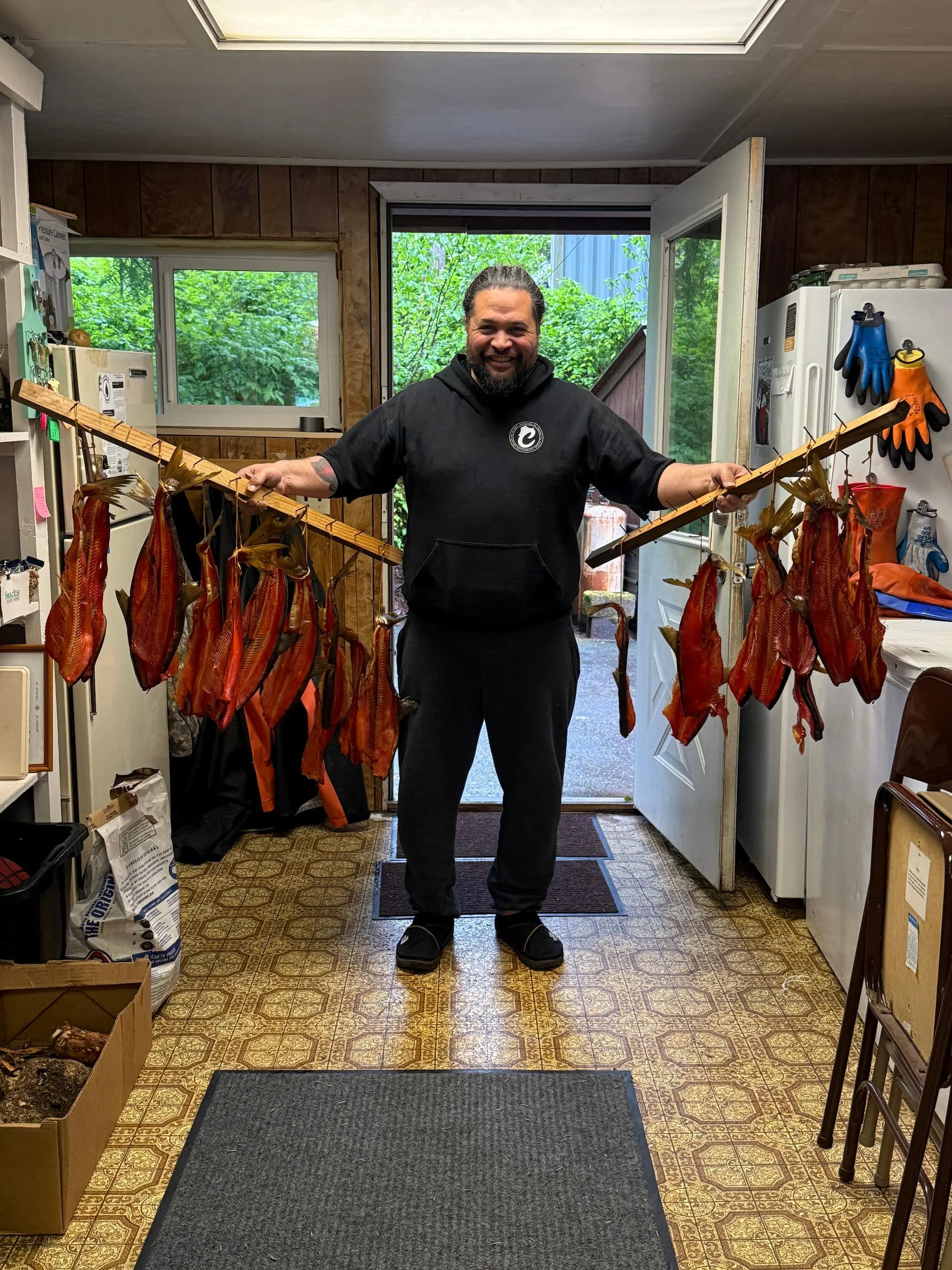 NativeCons_Keolani_Holding_Smoked_Fish–Photo_Credit-Evelyn_Booth.jpg