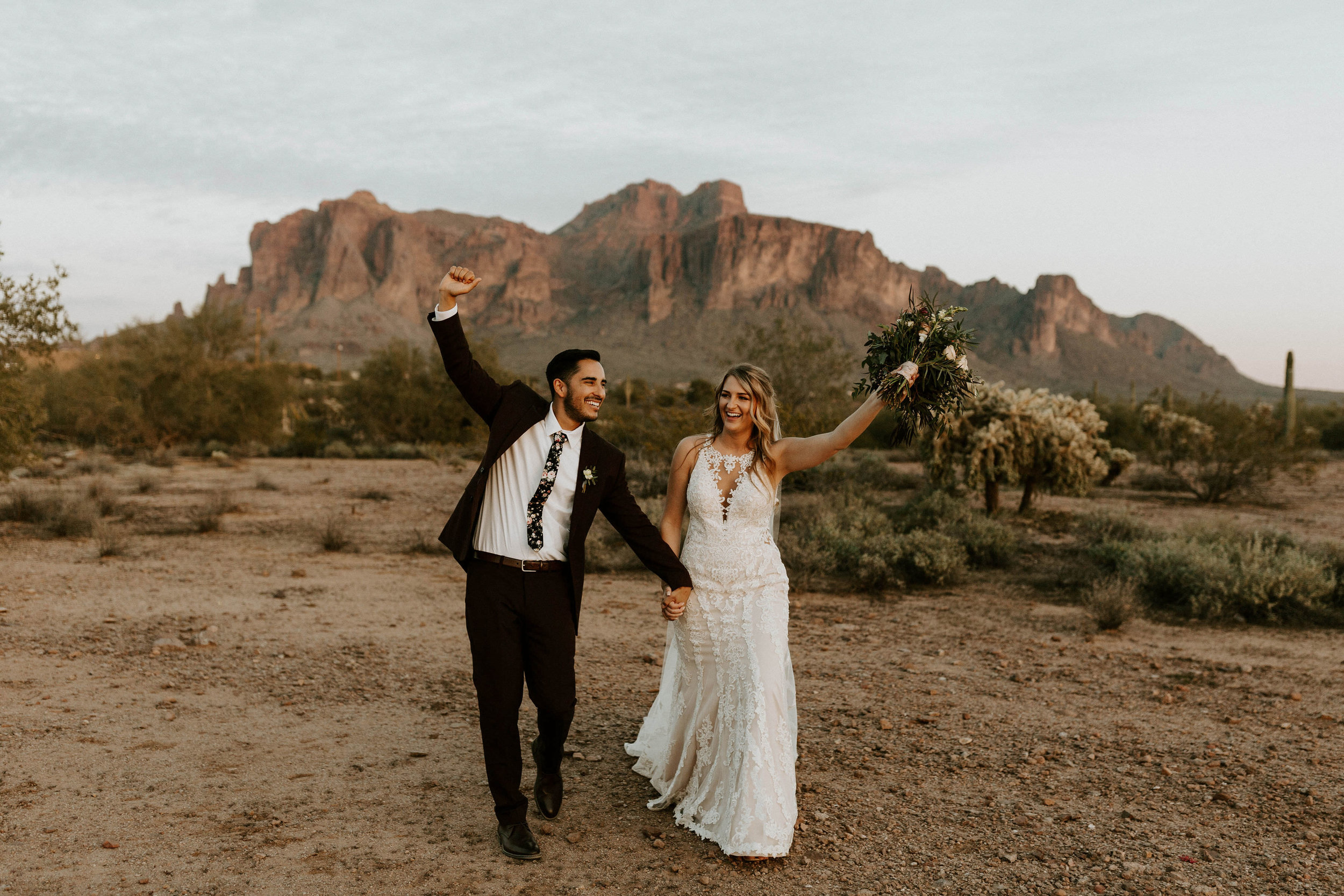 Bride and groom with Superstitious mountains in backdrop 