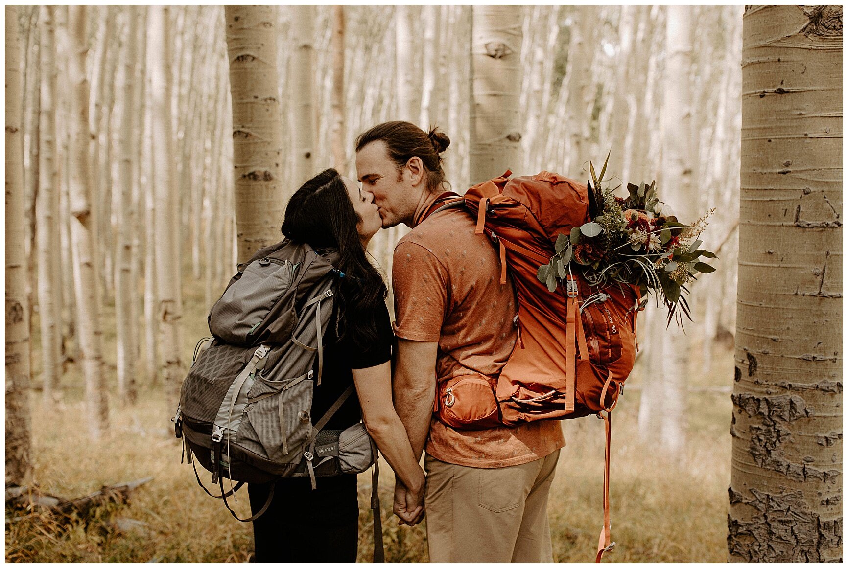 couple hiking up to their ceremony spot on their elopement day in flagstaff arizona