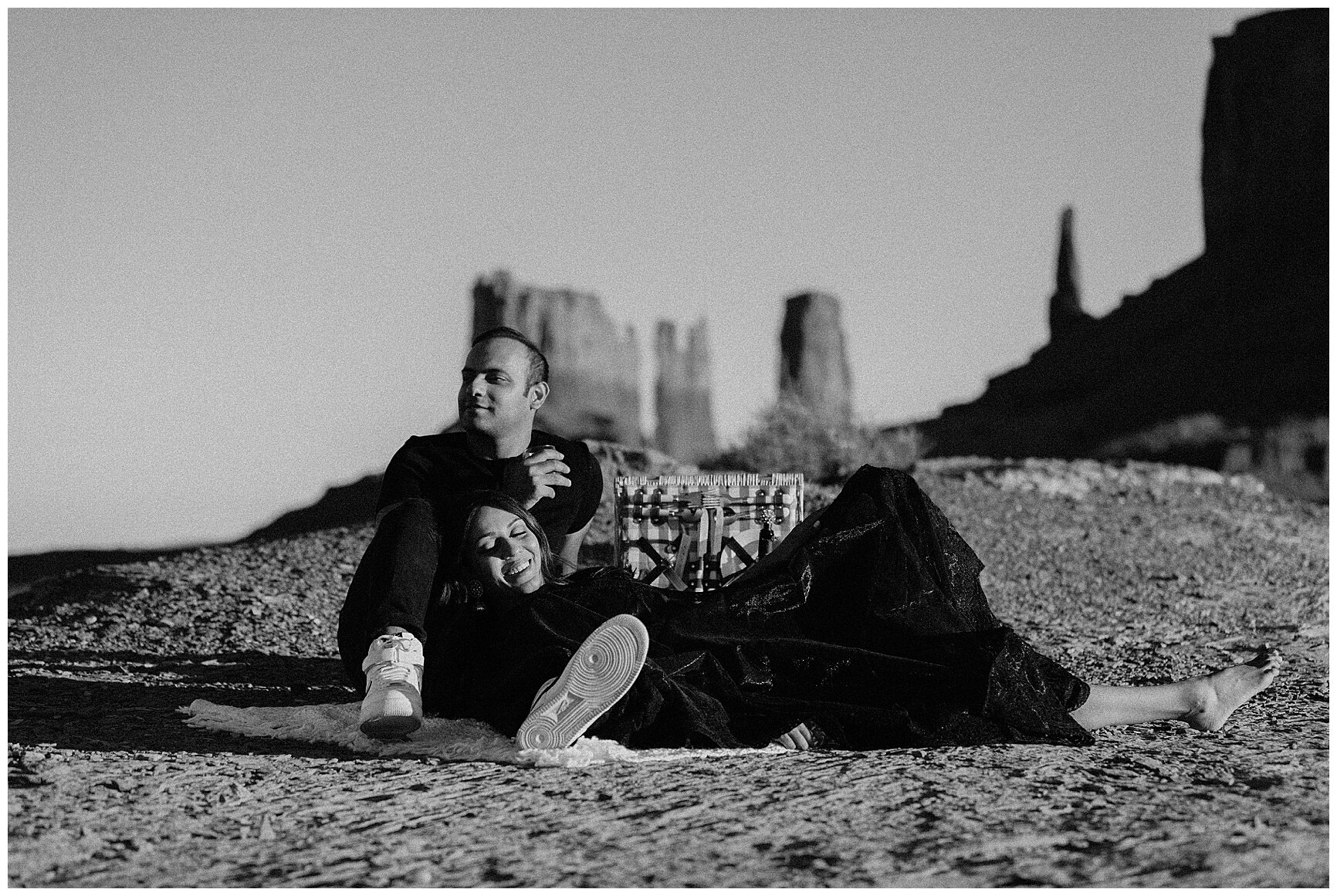 engaged couple having a picnic during their photo session in monument valley, arizona