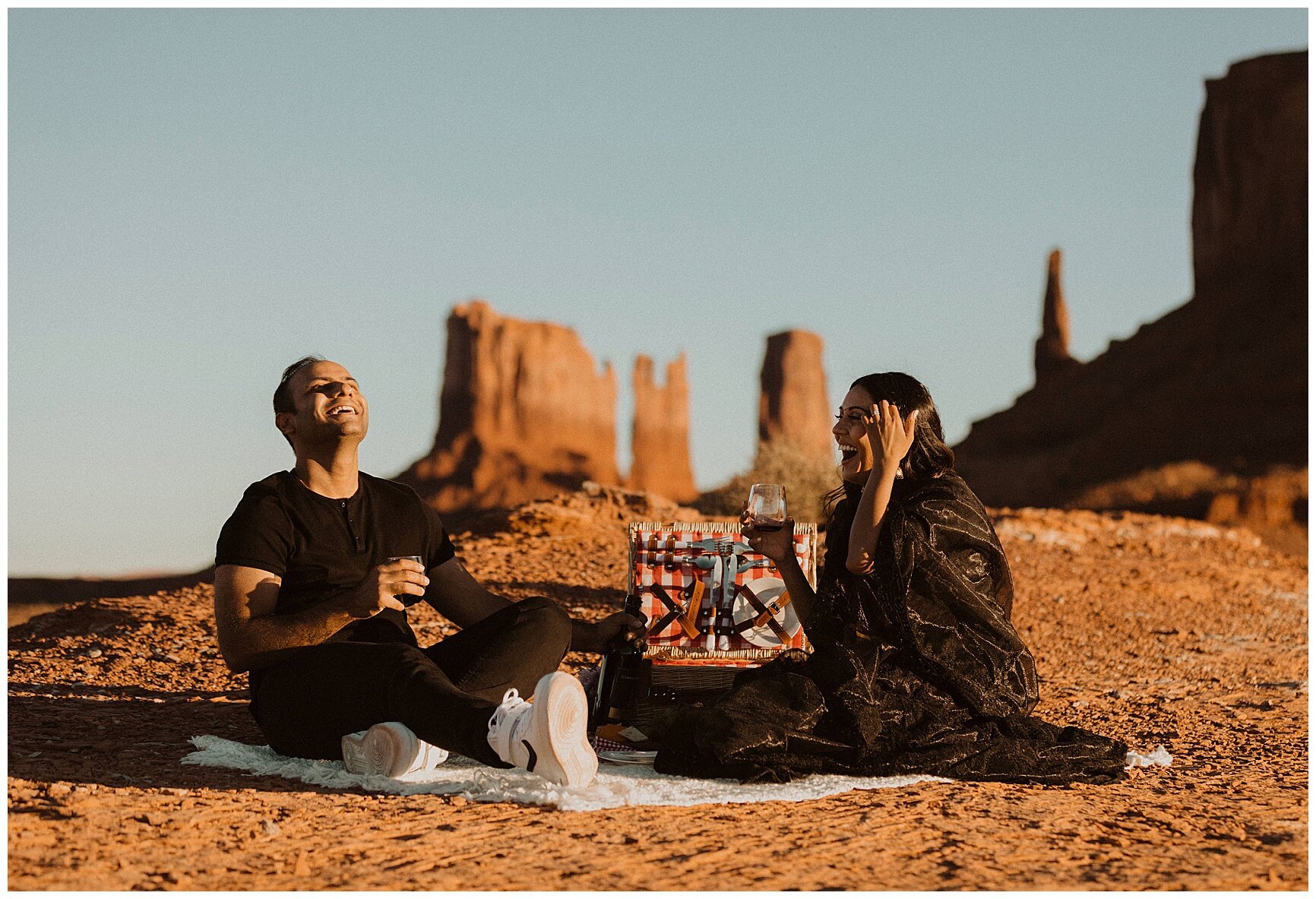 engaged couple having a picnic during their photo session in monument valley, arizona