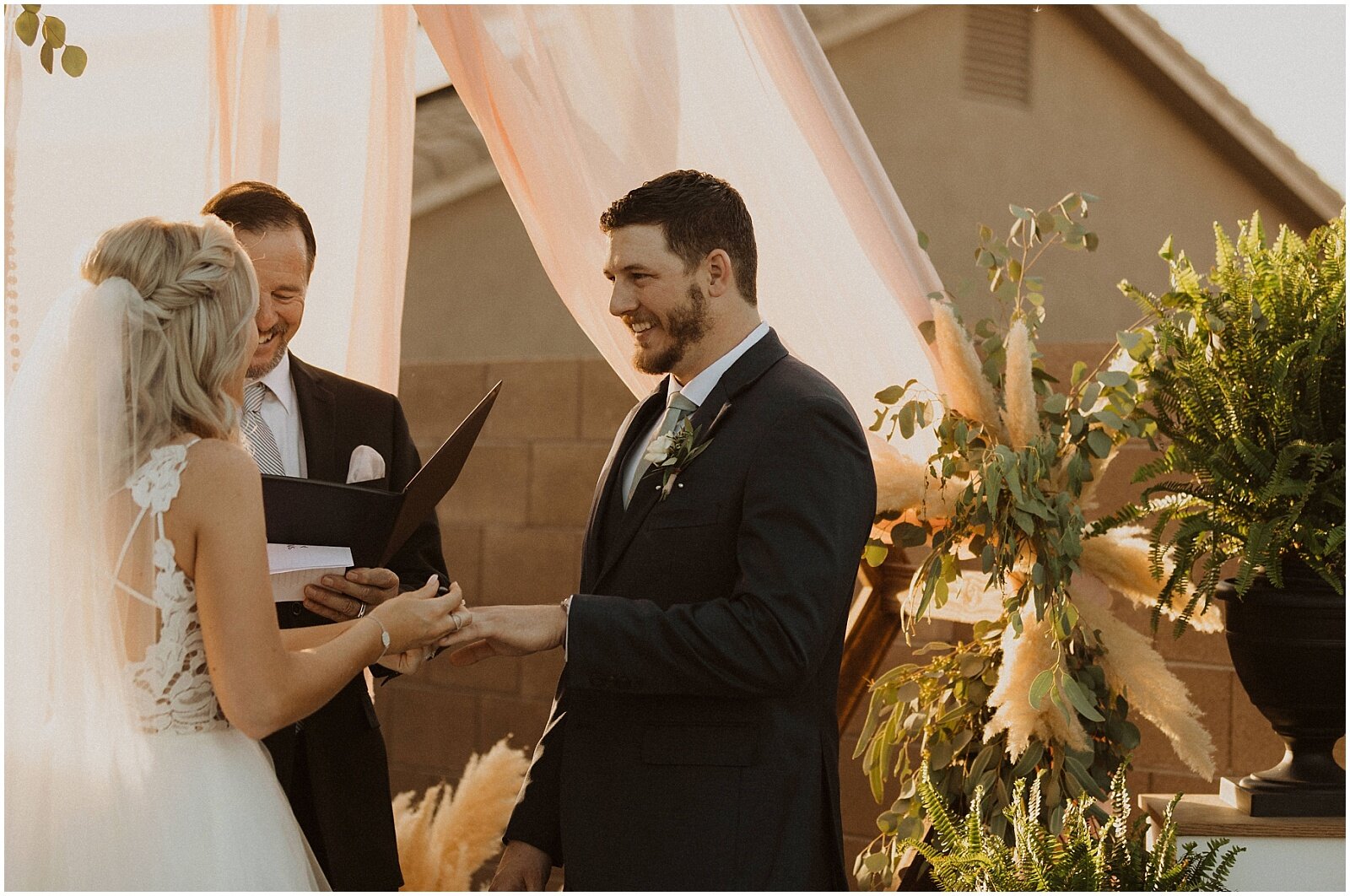 bride and groom exchanging vows during their intimate backyard elopement