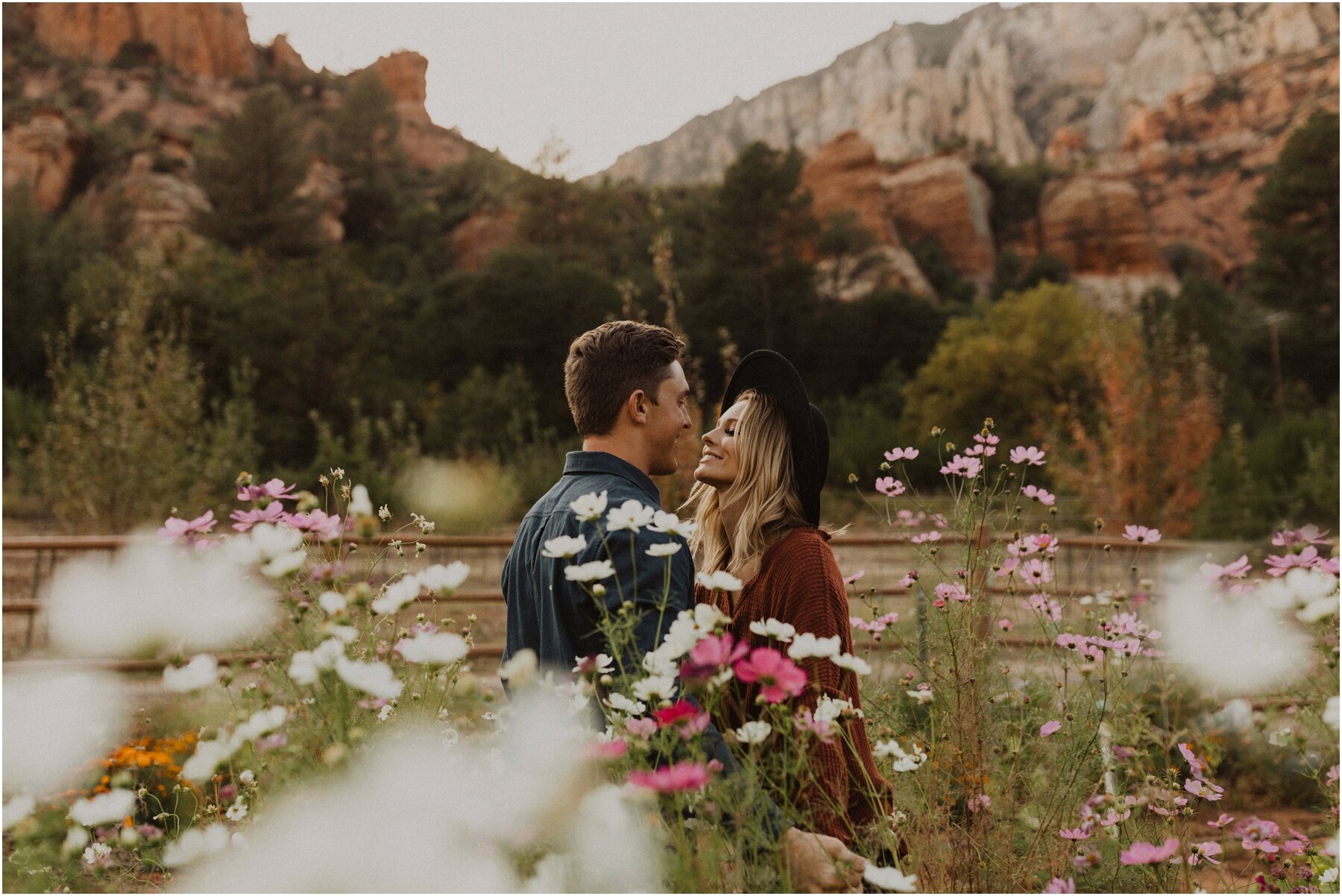 couple session among wildflowers in sedona arizona