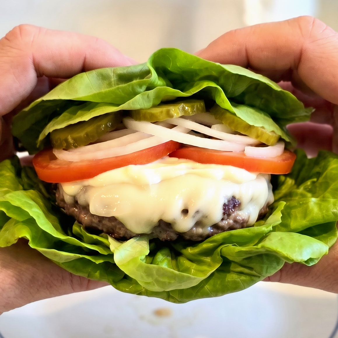 lettuce wrap burger with hands.png