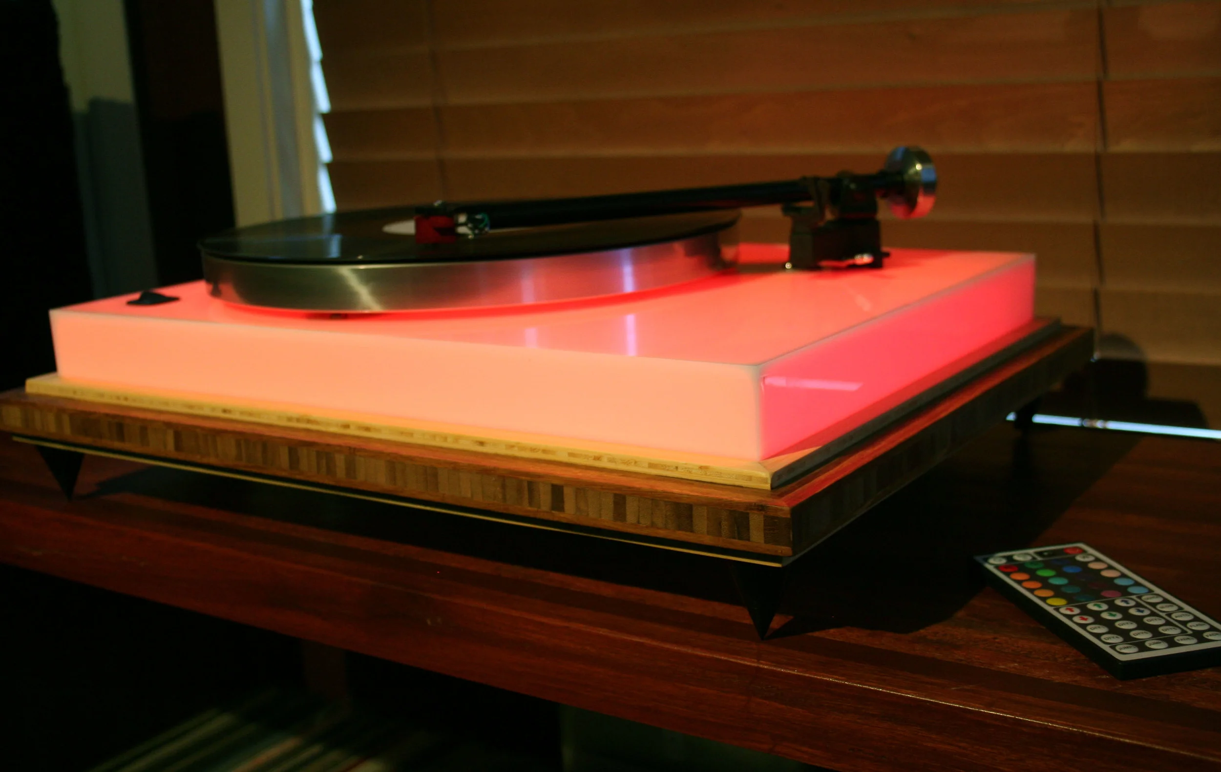 Color Acoustic Research T-bar, platter, sub-platter, opaque white plexiglass lined with 16 ft of LEDs/remote control, Rega 101 tonearm, Hurst 300 motor, AudioNote high output moving coil cartridge, real bamboo custom built base, rocker on/off switch, 2.5 inch metal spikes. On display at GHA ($999 w/cartridge).