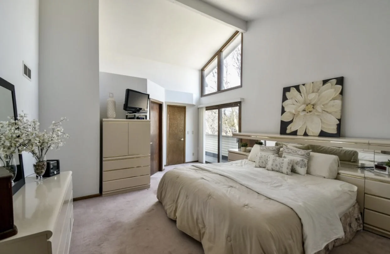 A master with high ceilings and a teeny little private patio! 