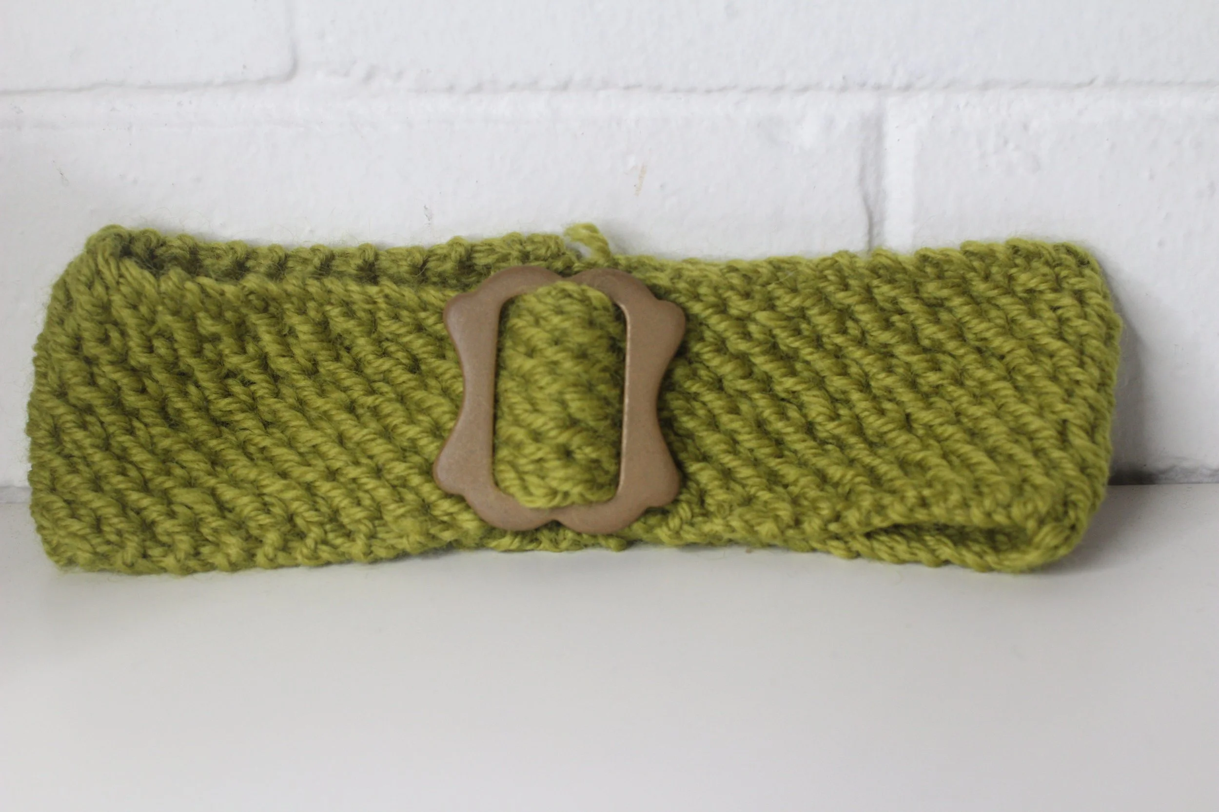 The House of hats grren knitted buckle headband .jpeg