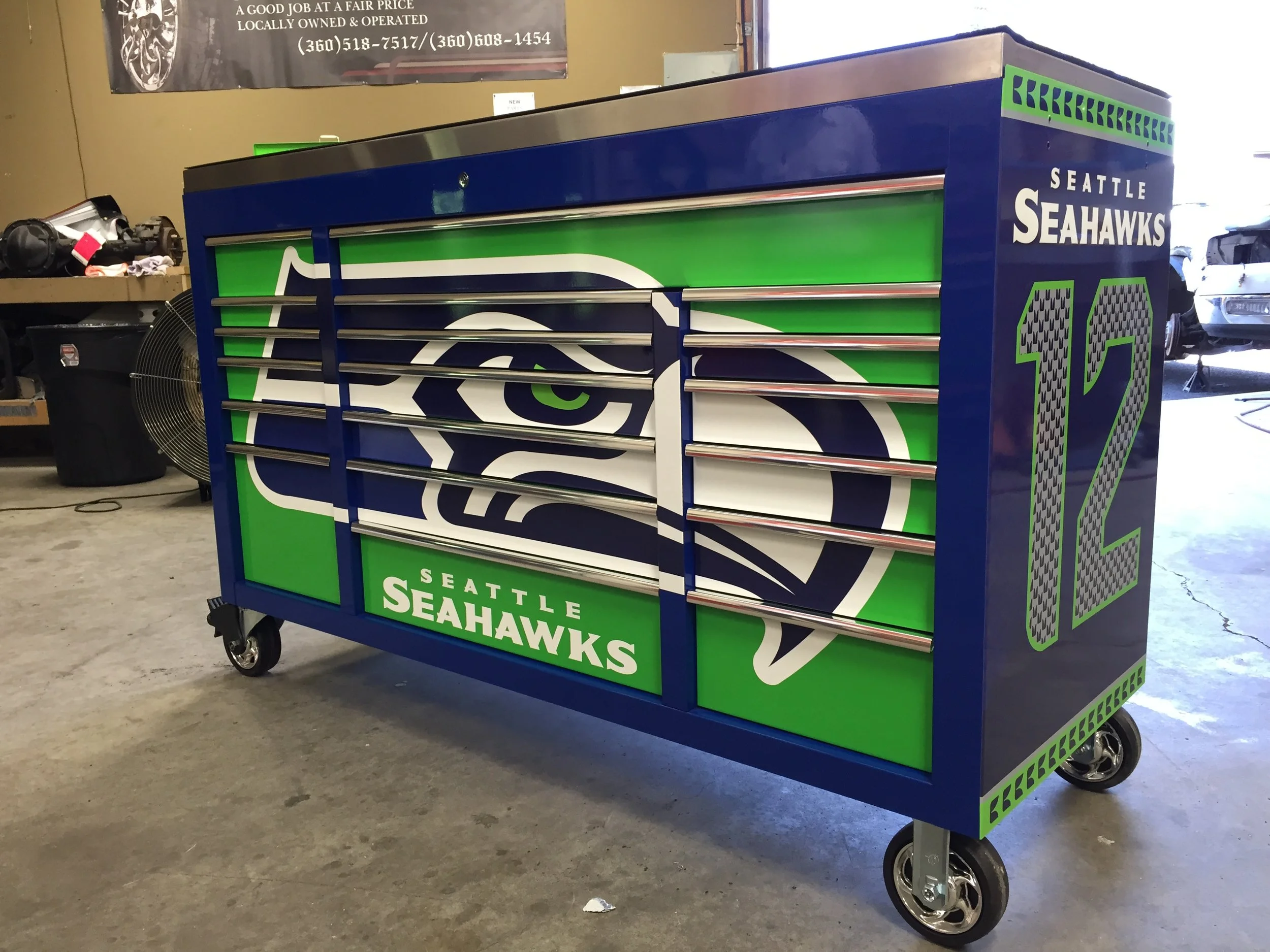  BOB’S GARAGE:  -Full wrap using printed c-tac with luster laminate. Custom Seattle Sea Hawks tool box for professional auto shop.  