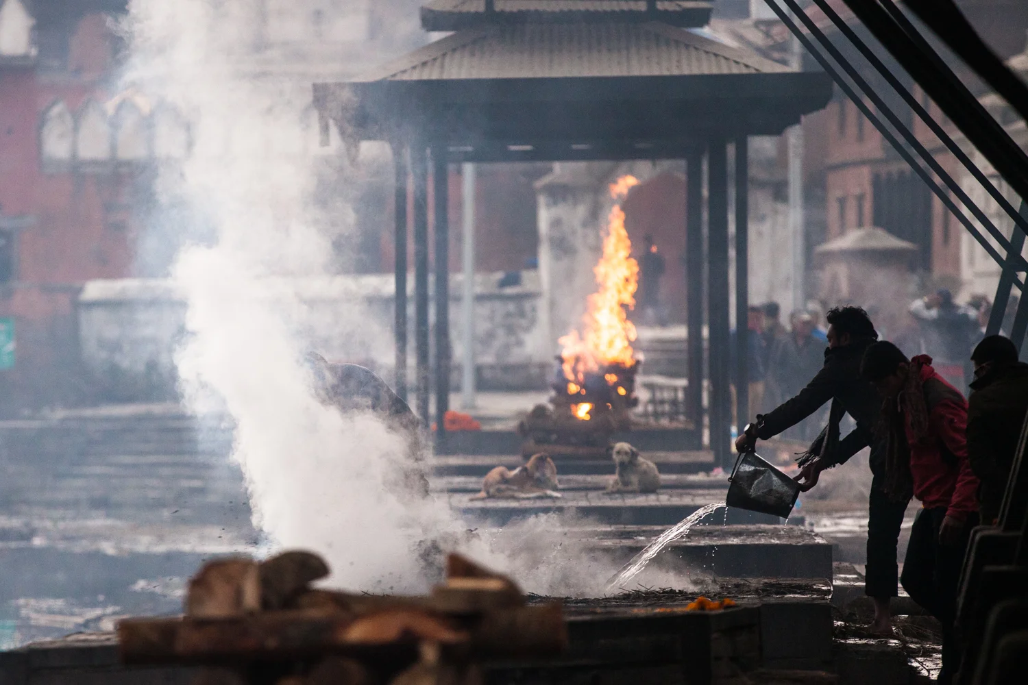 A man cools down hot cement for the next cremation ceremony at Pahupatinath Temple in Kathmandu.