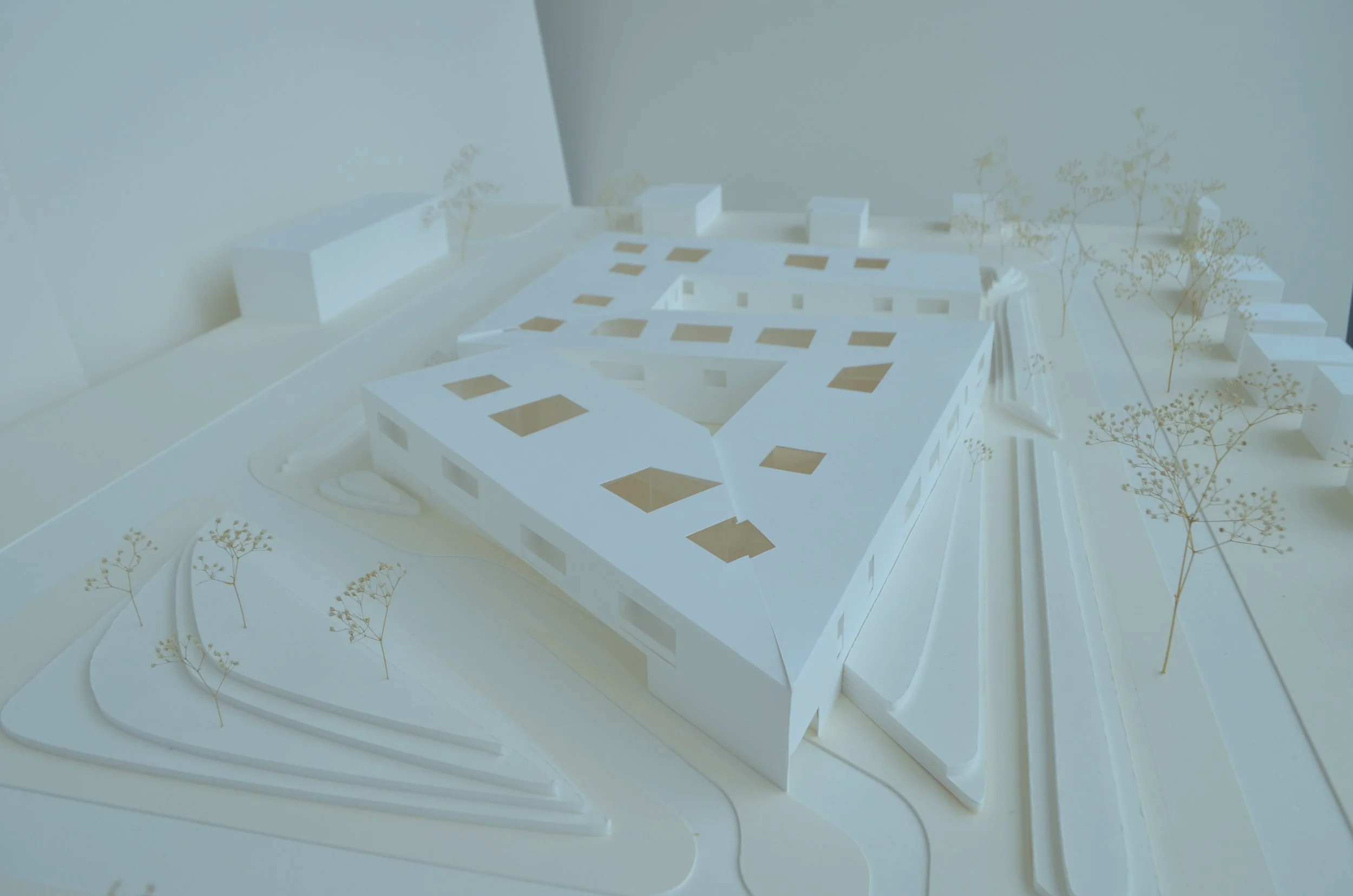 White model of a zig-zag building shape with skylight cut outs.