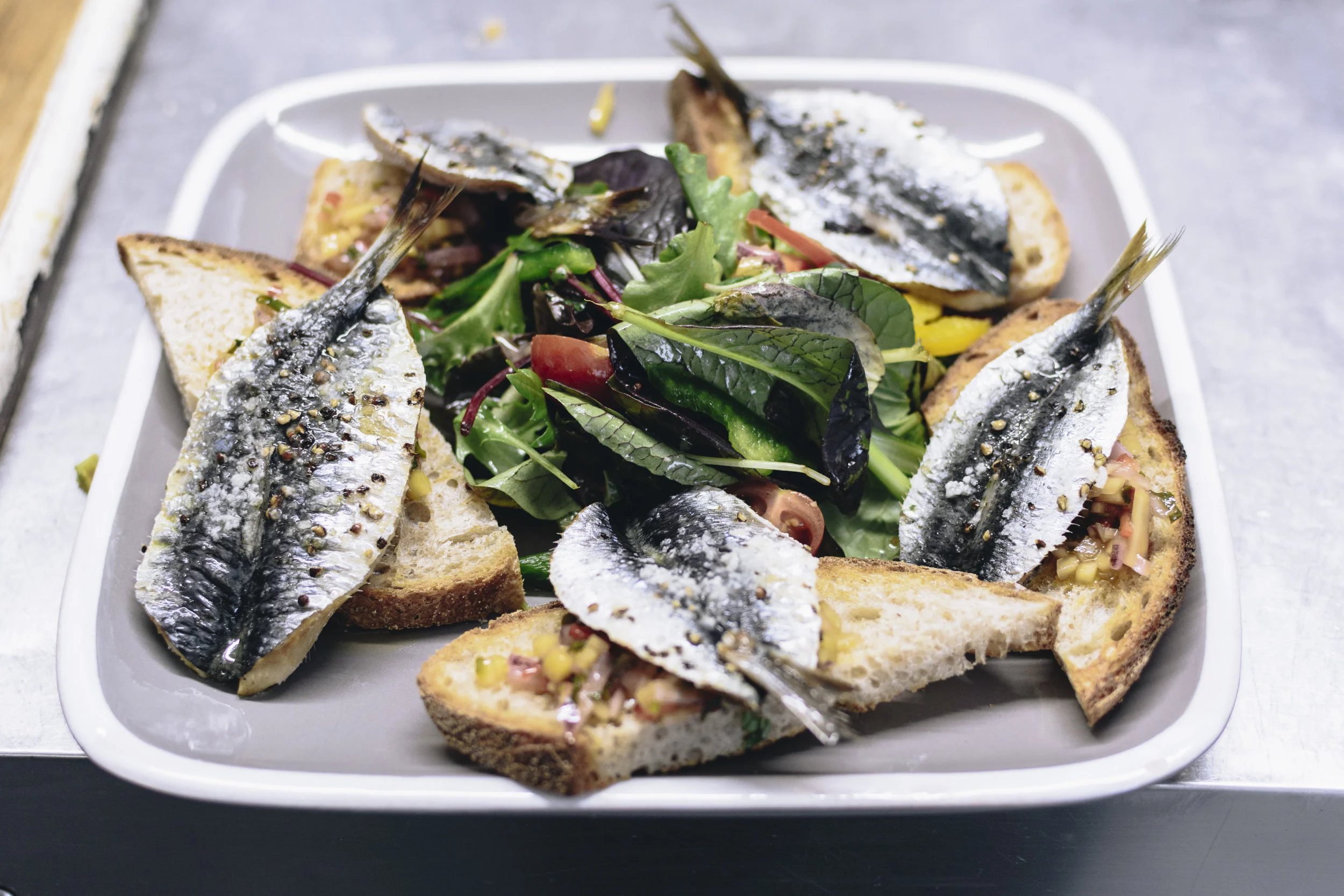 Sardines on toasted sour dough with a mango salsa