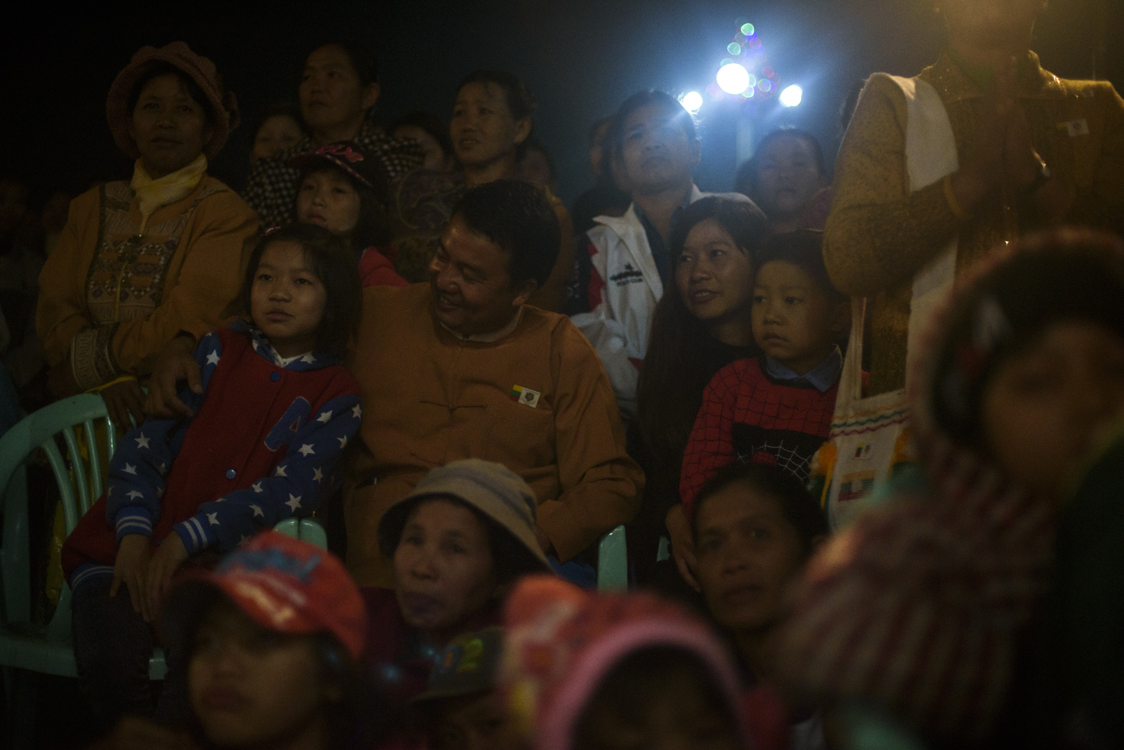 One Leng watches the concert with his wife, daughter and son amid a crowd of supporters.