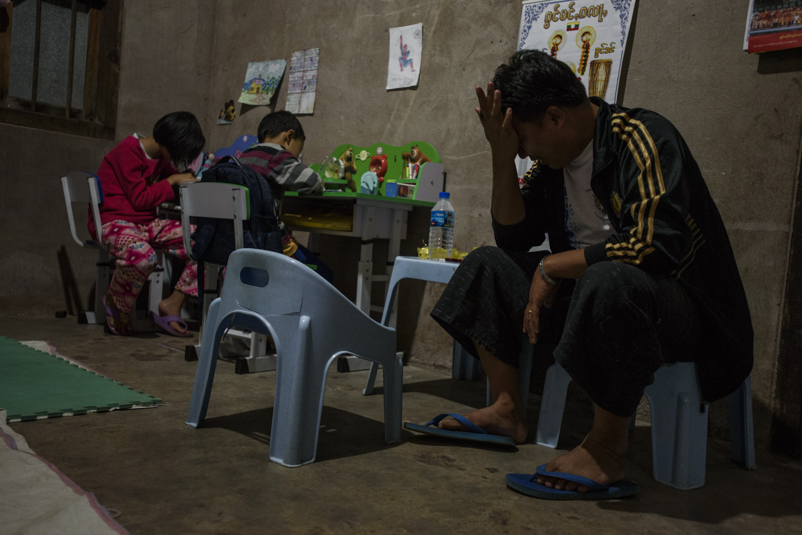 One Leng at home at the end of a day of campaigning, His children are doing their homework, but have taken some days off school to help their father.