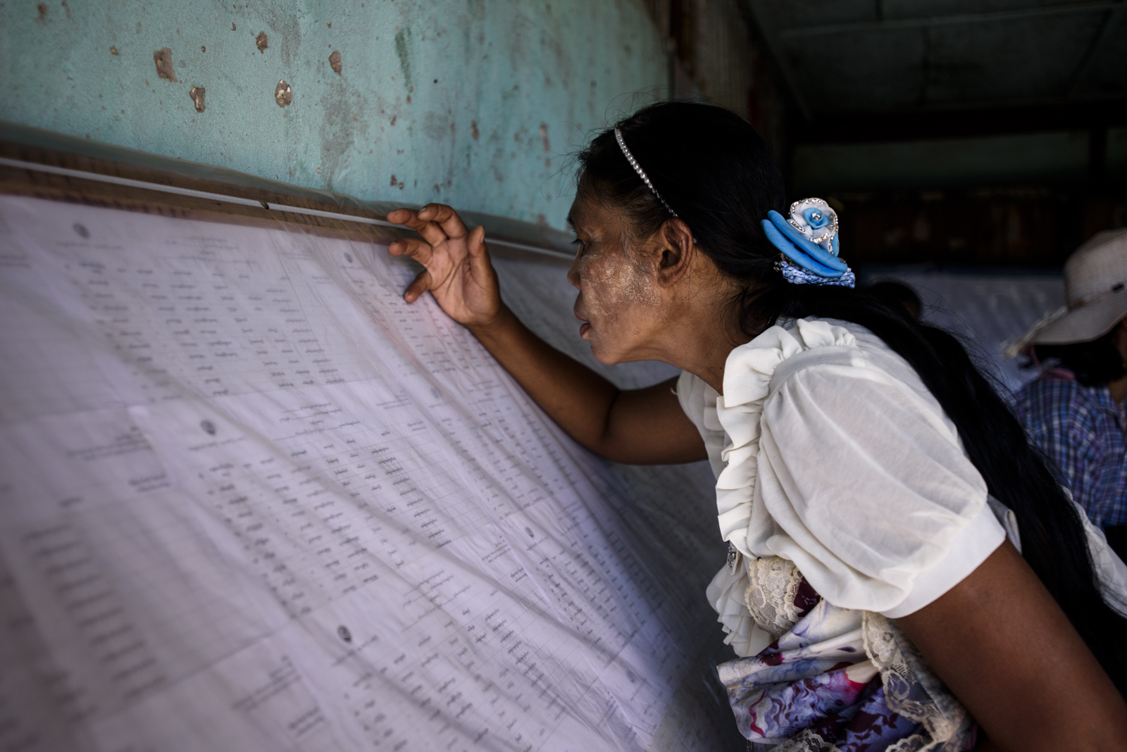 A voter looks for her name at a polling station. Only those on an official list were allowed to vote.