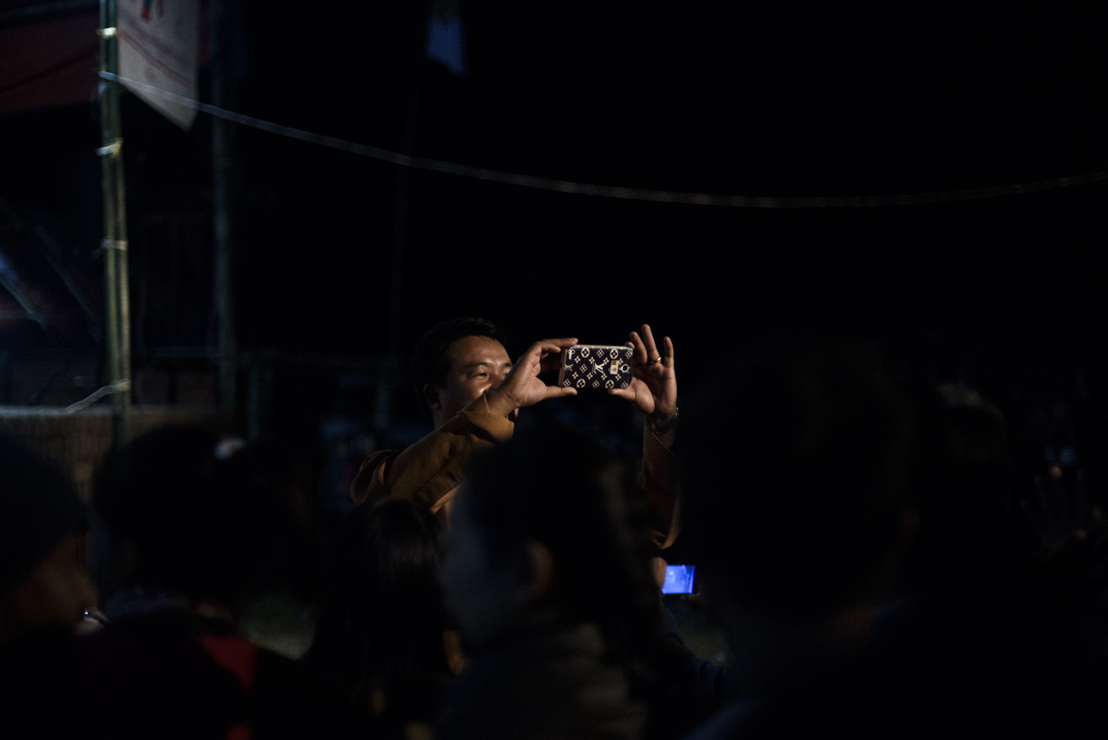 One Leng takes a photo of the crowd. He is constantly on Facebook posting campaign updates.