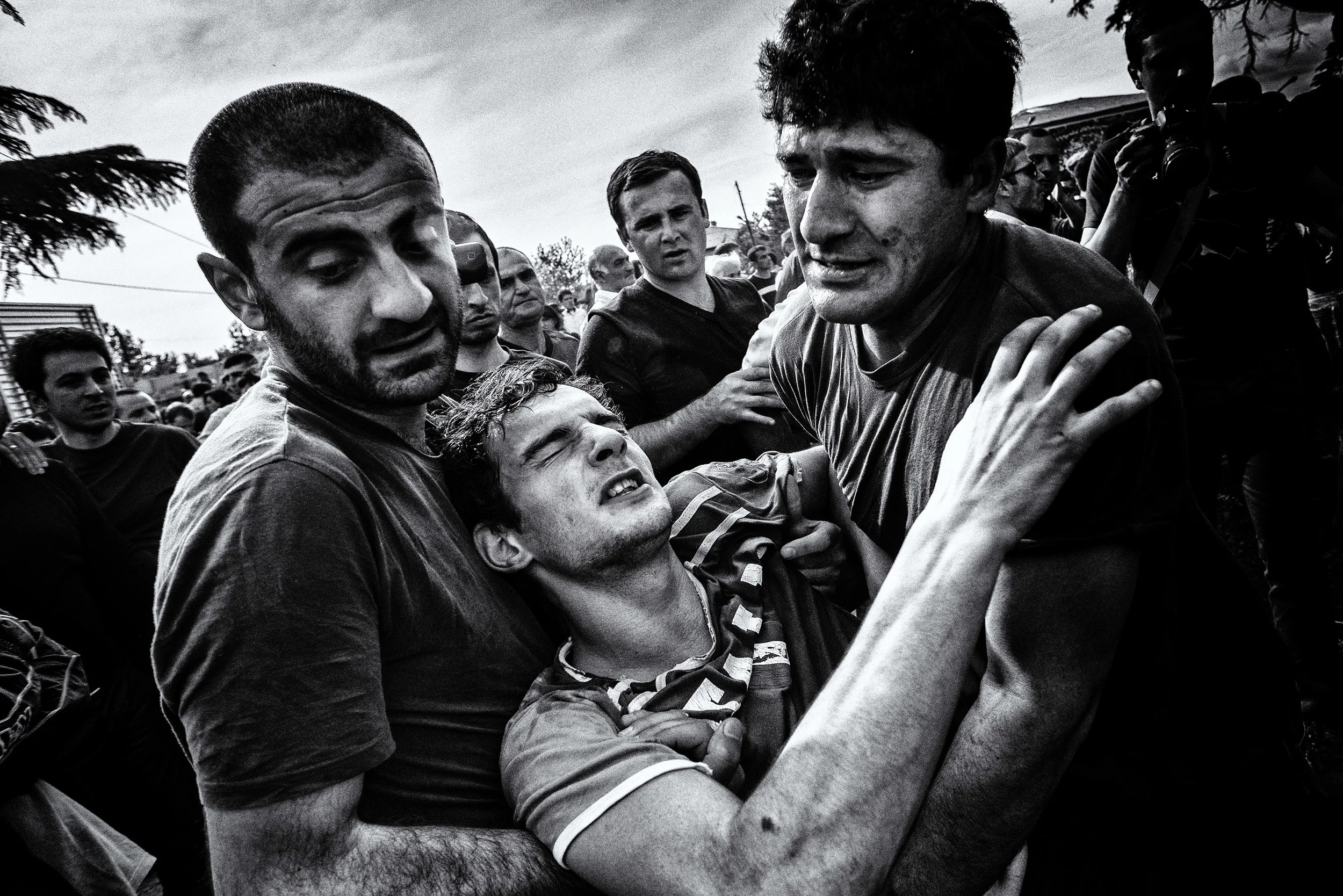 Only 15 minutes after the start the first injured people are carried away of the big melee. Usually they recover after few minutes and go back to play. Shukhuti, Georgia, April 2014.