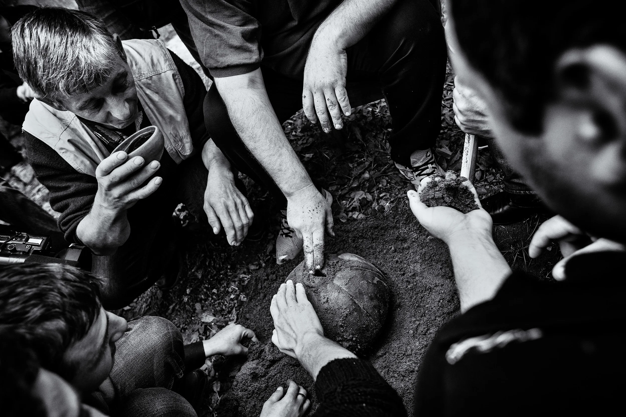Every Easter's Sunday people of Shukhuti gather at the old shoemaker's home to celebrate Easter, alcohol and food are being shared meanwhile some men make a 16kg ball with sand, wine and leather. Shukhuti, Georgia, April 2014.