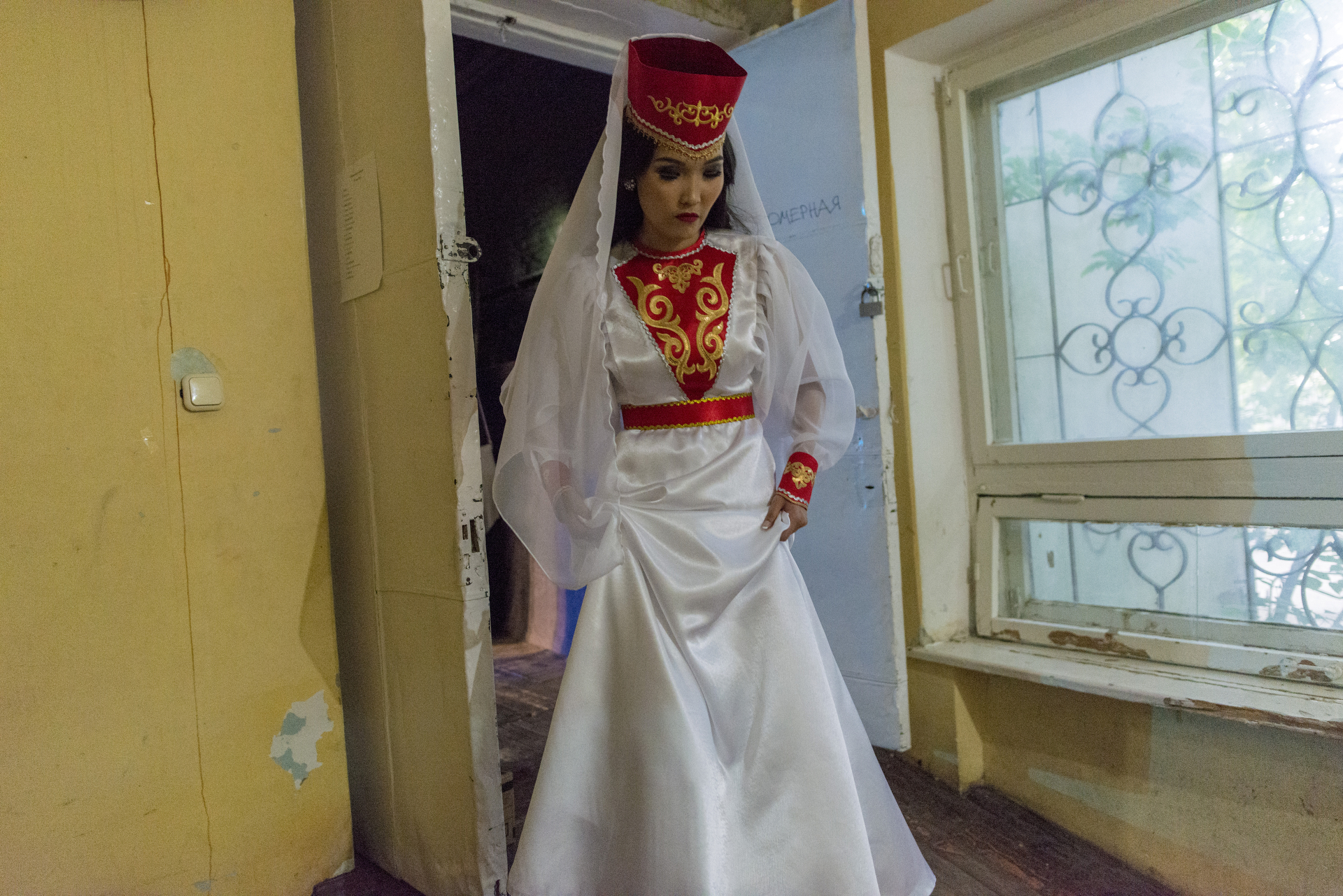  Woman wearing the traditional kalmyk dress at the backstage of the Philharmonic Theatre. Elista, Russia, May 2016. 