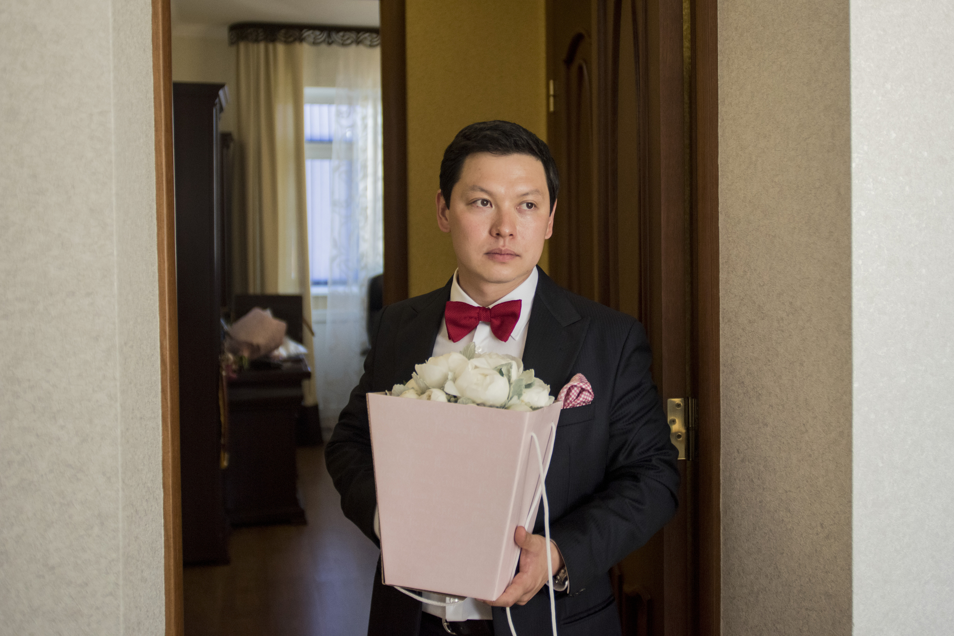  Alexey Makarov carrying a wedding bouquet. The tradition in Kalmykia states that before the ceremony the groom has to pick up the bride from her parents home. Kalmyk's has abandoned most Mongolian wedding traditions to a more international approach 