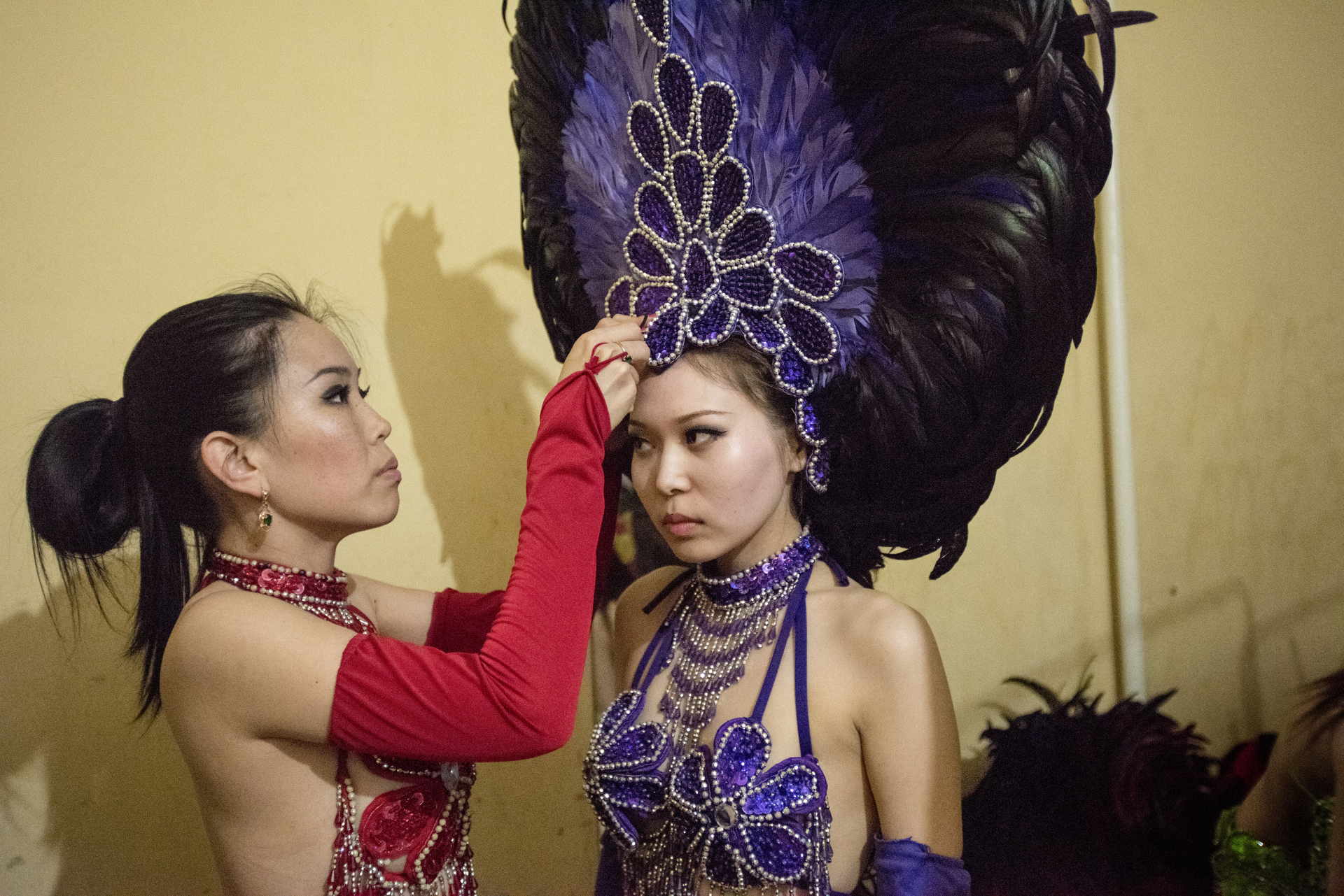  Two members of the Empire Dance Ballet Show are getting ready to perform. With their Carnaval Brazilian style, this company is well known in Elista and usually performs in all kinds of public events, parades, parties and weddings. Elista, Russia, Ma