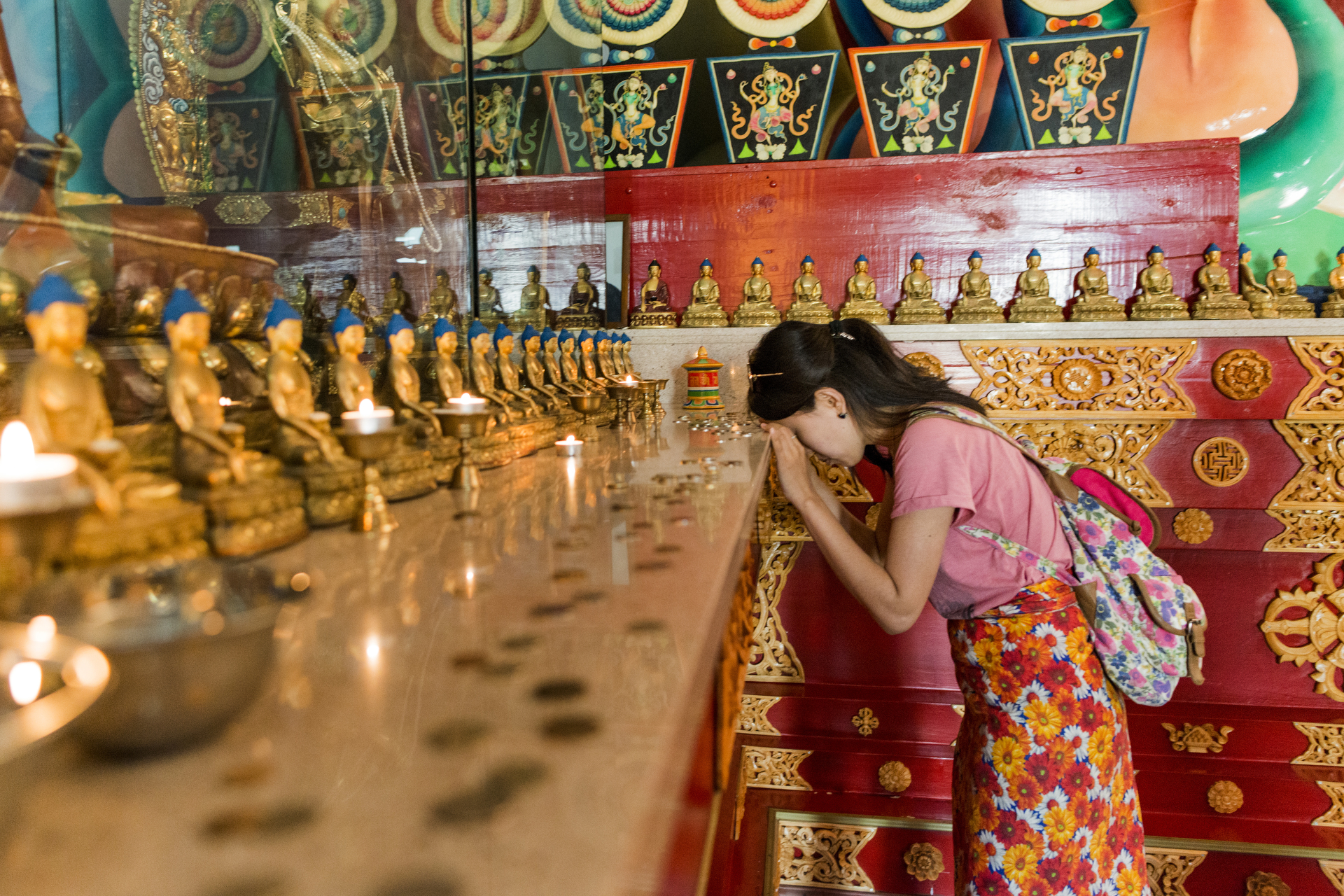  A young woman prays inside the main Buddhist temple of Elista, know locally as a Khurul, in Elista, Russia, June 2016. 