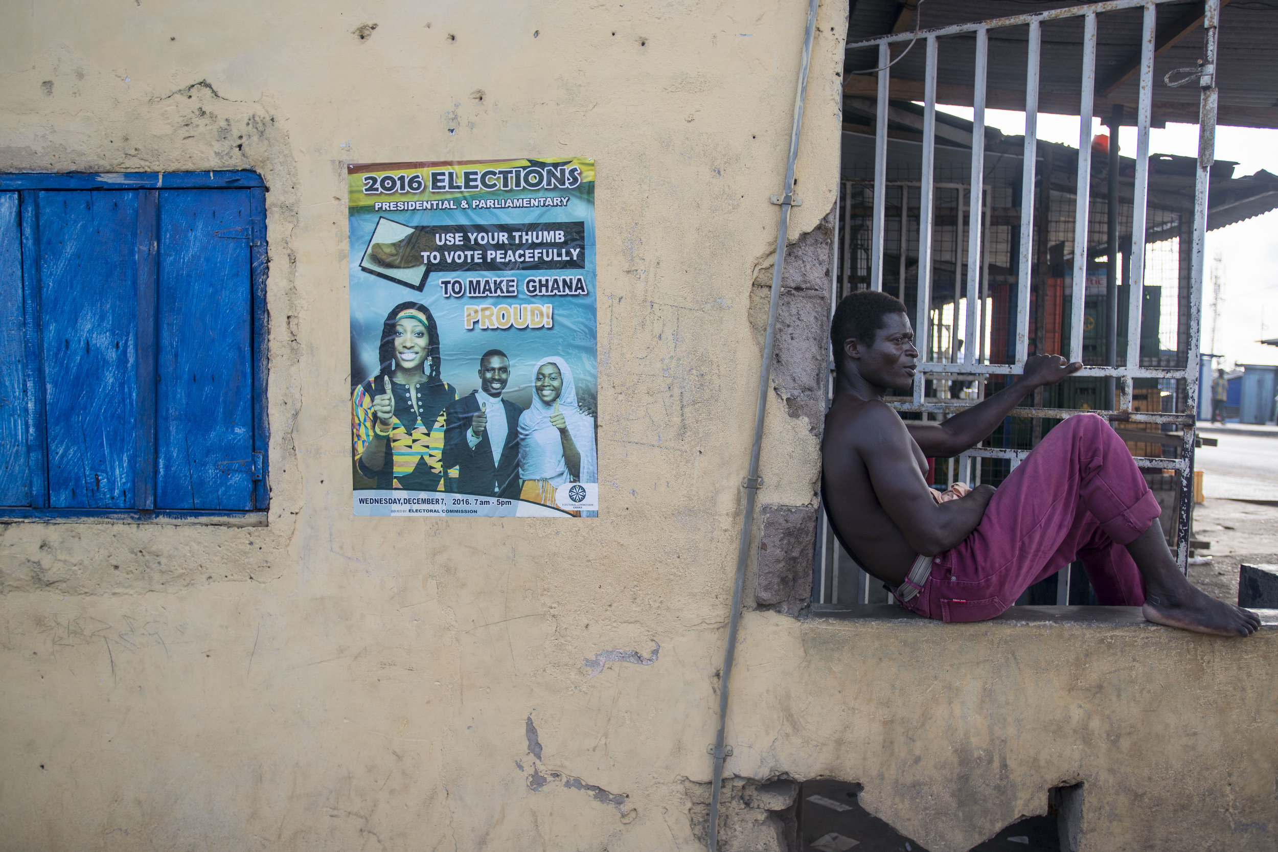  A man rest in a tailor shop on the neighbourhood of Teshie, Accra. As the country prepares for the incoming general election on 7th December, billboards and advertising promoting a peaceful election can be seen all around the city of Accra 