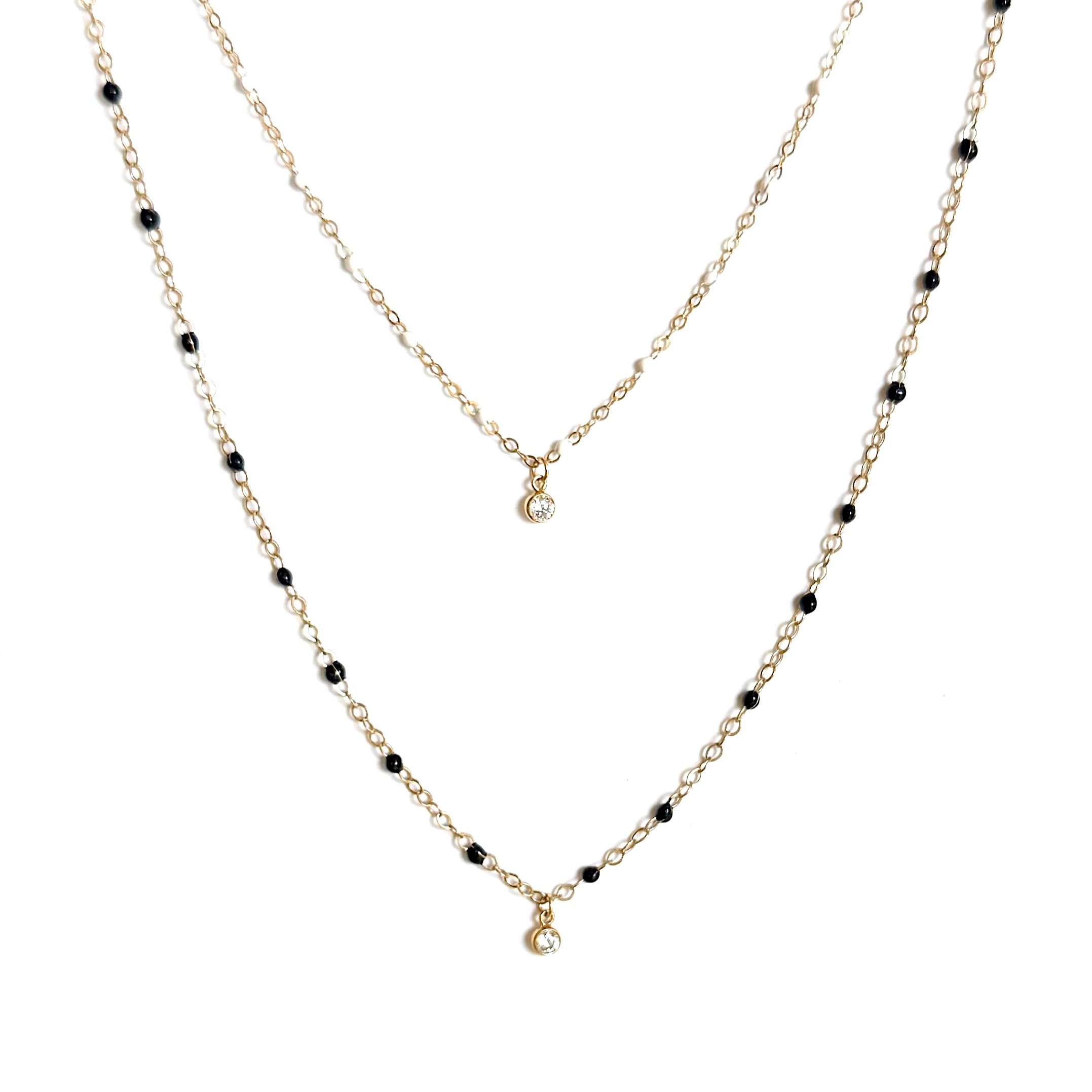 She wore an itsy bitsy teenie weenie black &amp; white dotted necklace 🎶 It's late summer and you're thirsty for a little pick me up. Voila! These Micro Beaded necklaces with a little diamond-like solitaire is the perfect remedy. Online &amp; in sto