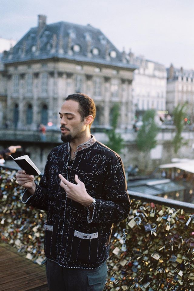 Malik reading in Paris. Image courtesy of the artist.