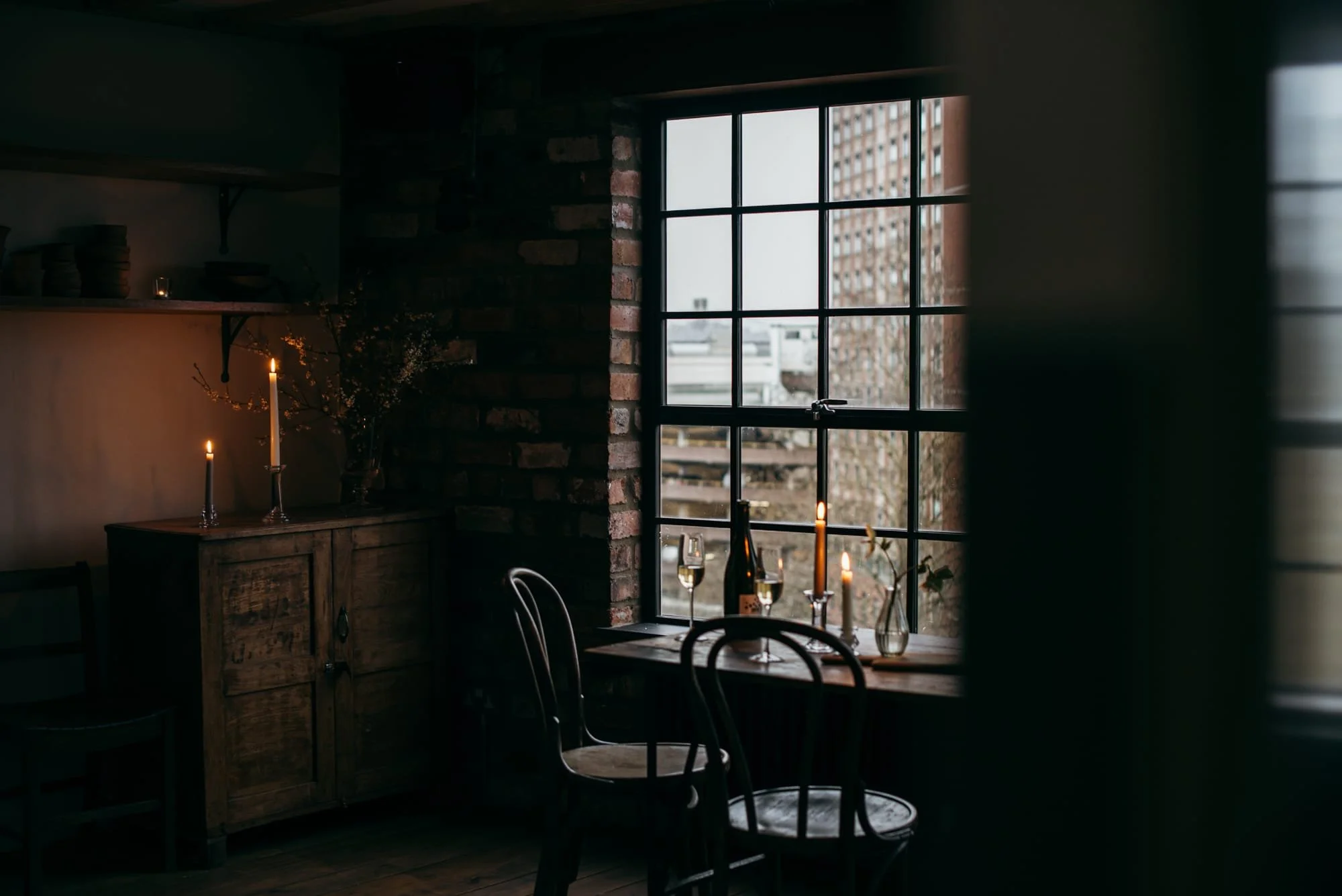 Candlelit winter wedding interior with window views at an intimate Bristol venue