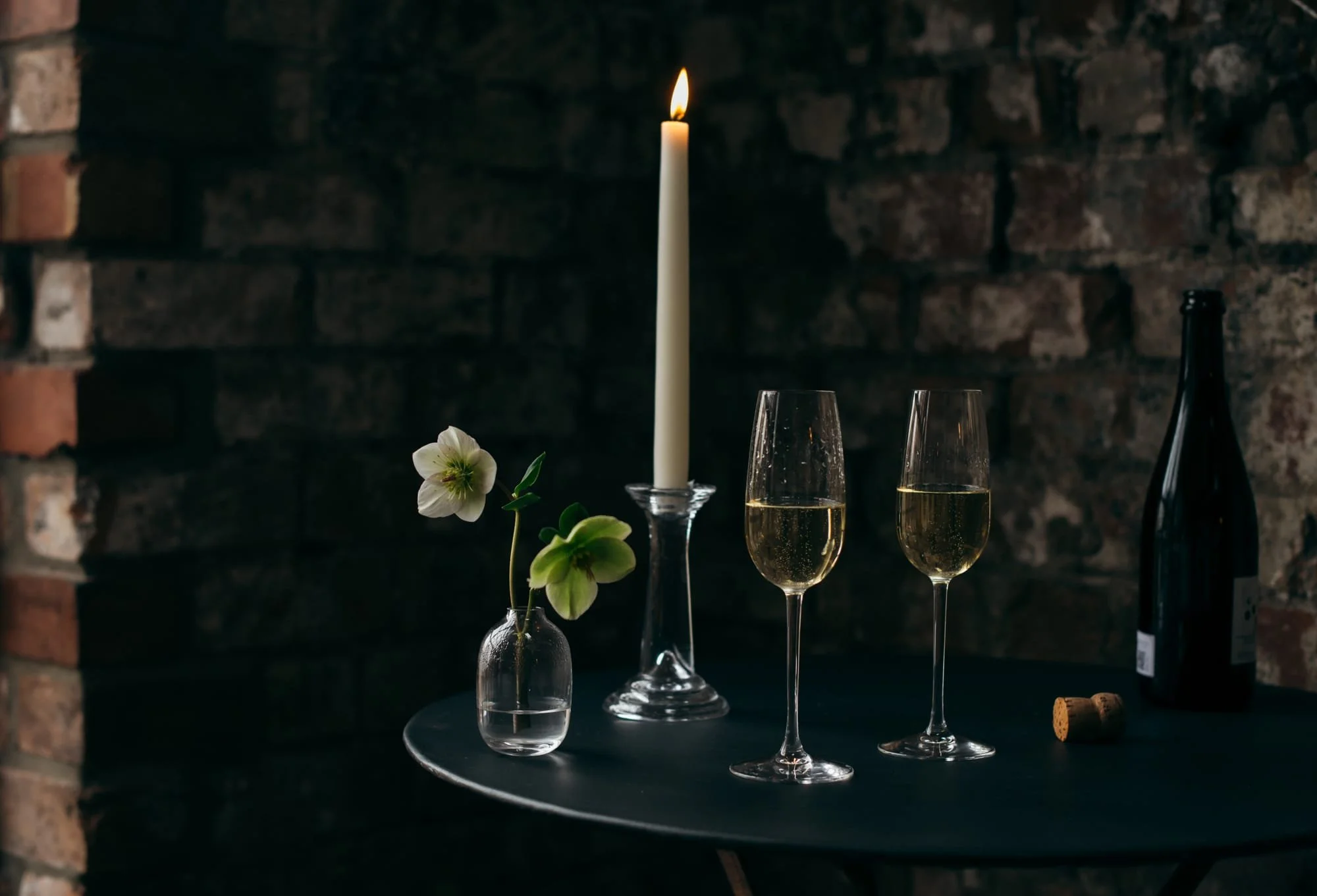 Candlelit winter wedding drinks with champagne glasses and floral styling at a Bristol venue