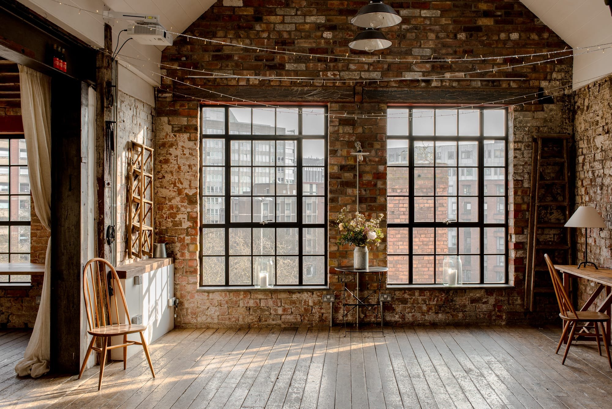 Industrial loft-style wedding and event venue in Bristol with exposed brick walls, wooden floors and large Crittall-style windows