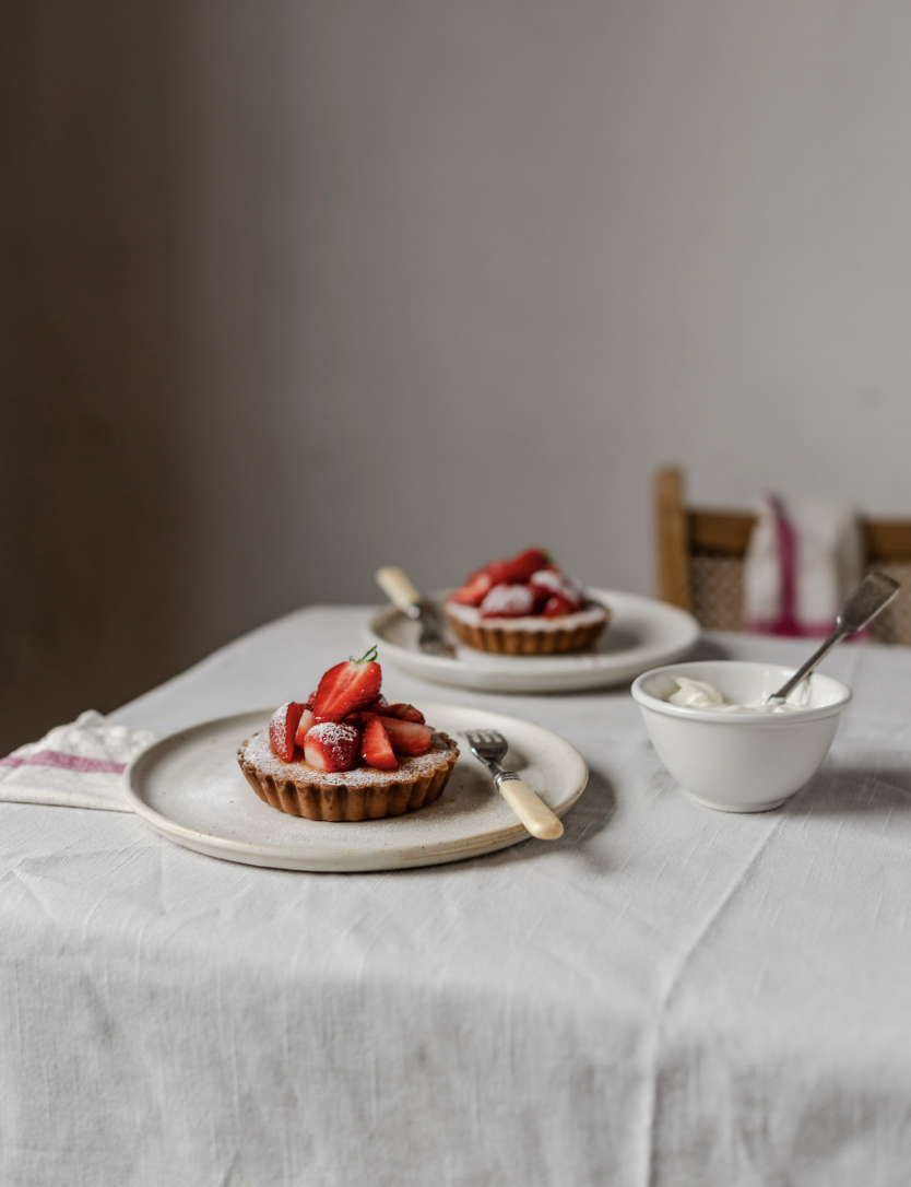 A beautifully styled private afternoon tea at The Forge Bristol with strawberry tartlets and fresh cream