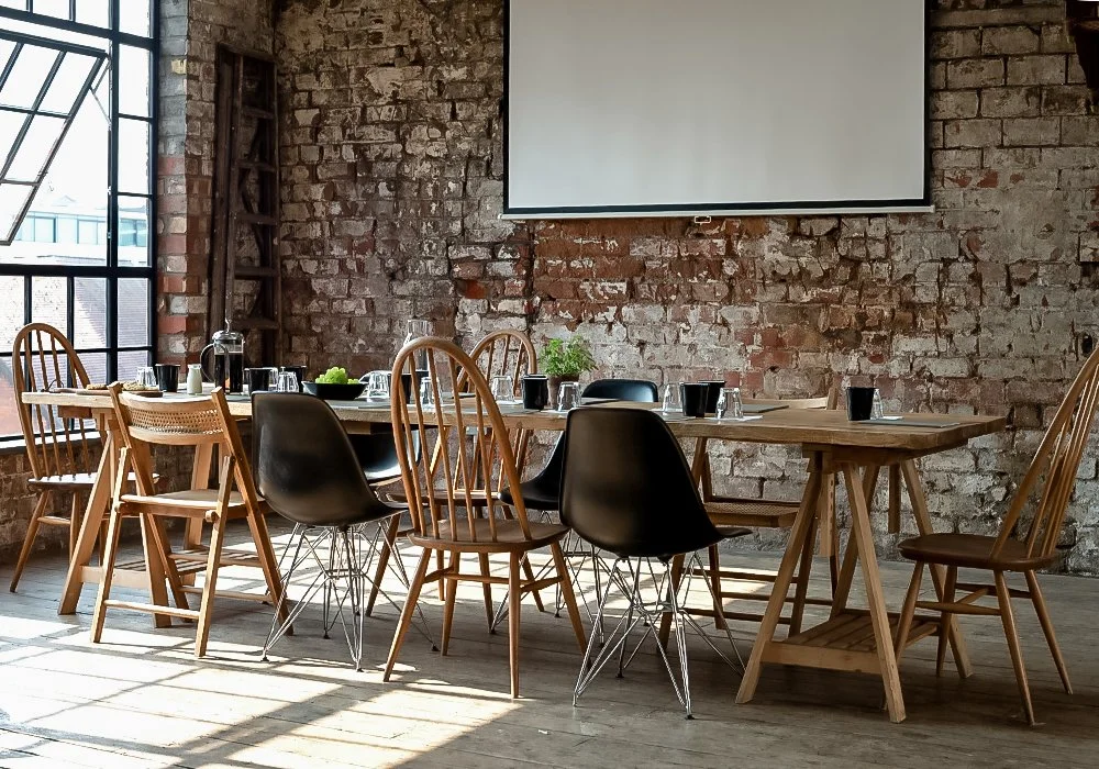 A bright and characterful meeting space with exposed brick, natural light, and a stylish setup—perfect for business meetings, away days, and corporate hire in Bristol